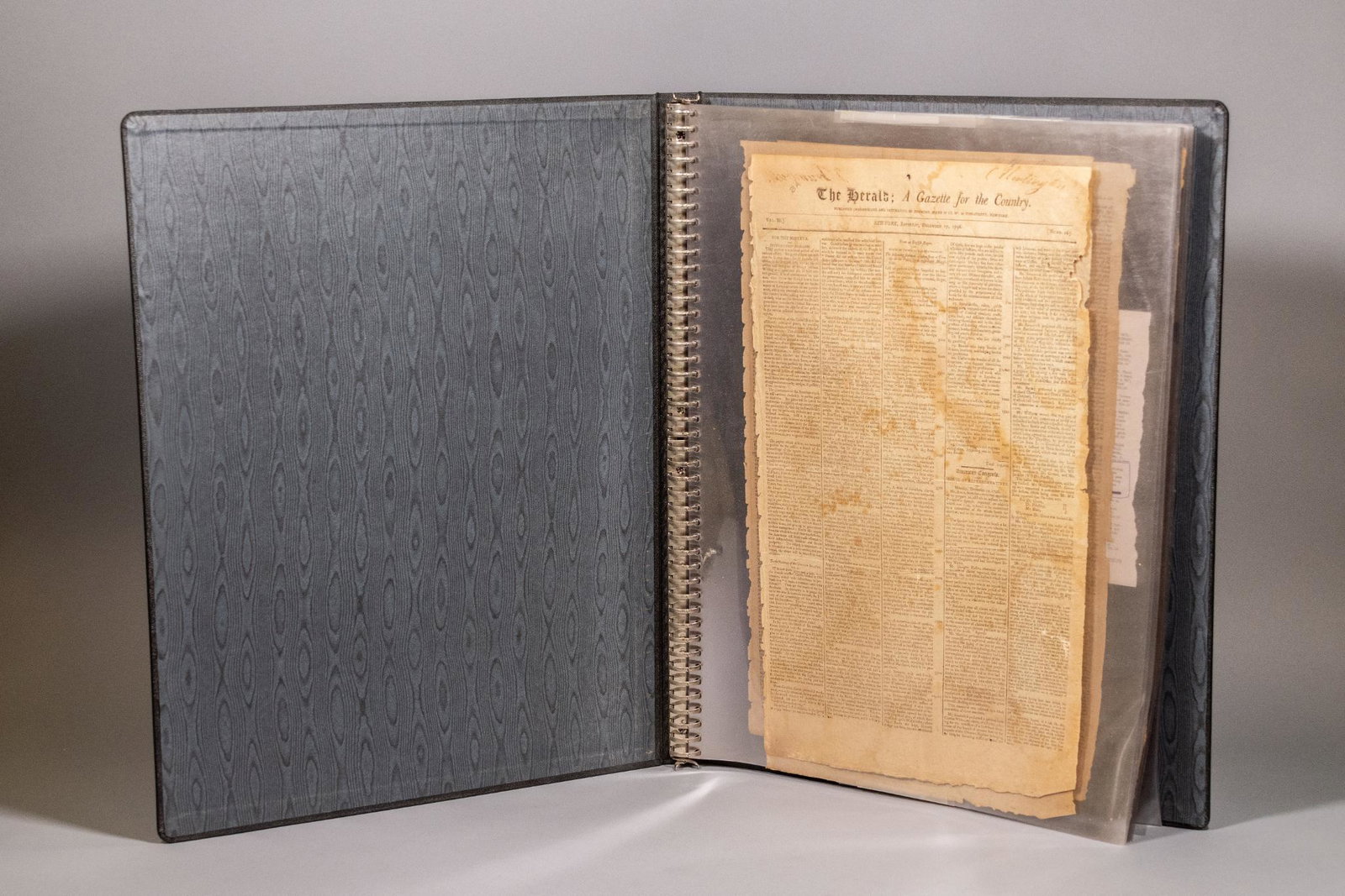 Folio of Historical Newspapers: A binder with nine (9) historical newspaper pages in mylar. Issues included: The Herald, December 17, 1796- The Herald, March 30, 1796- Courier of New Hampshire, January 11, 1800- Connecticut Courant,
