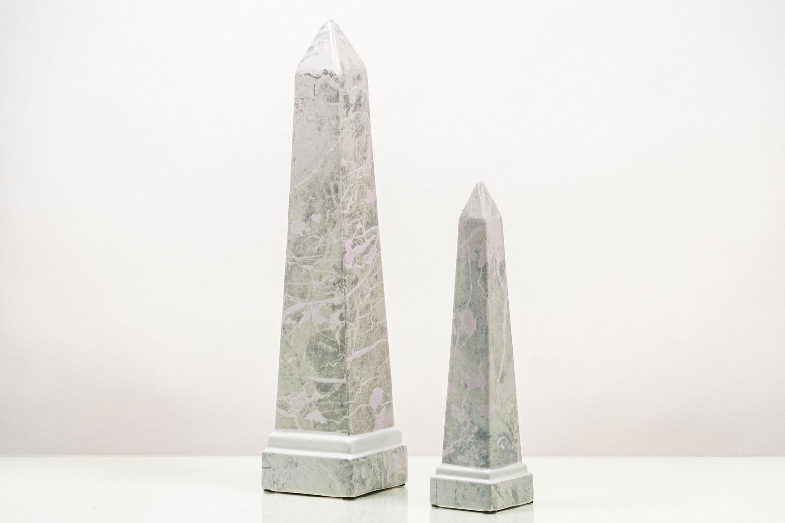 Title Set of Two (2) Ceramic Obelisk Figurines: DescriptionSet of two (2) ceramic obelisk figurines. CONDITION: Excellent DIMENSIONS: H 18.5” x W 4” x D 4” for one (1), Small H 12” x W 3” x D 3” for one (1)