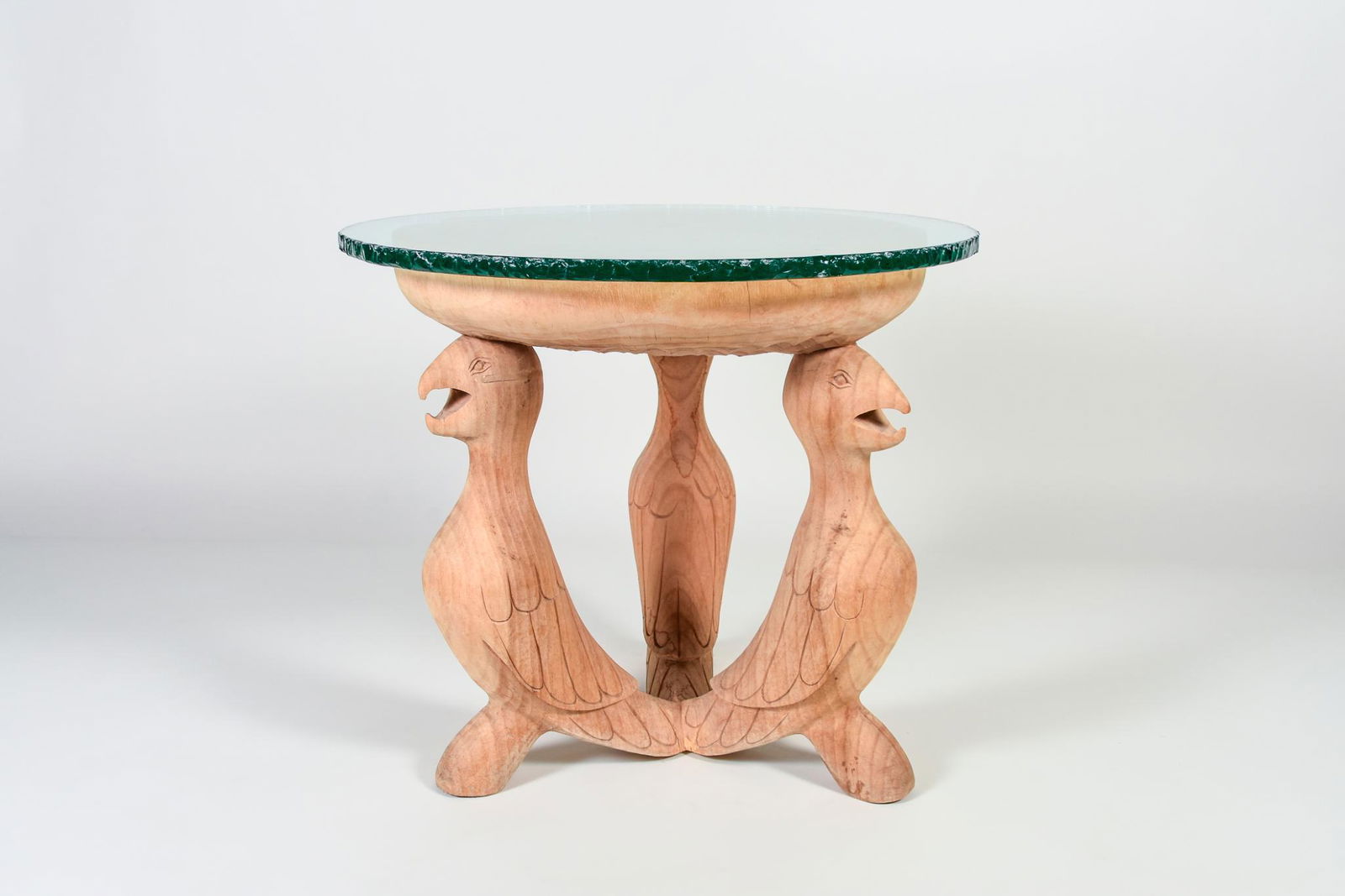 Carved Wood End Table with Bird Base and Glass Top: Carved Wood End Table with Bird Base and Glass Top. H23" x D26" Wood has a split on the top and one bird tail is split, glass top has some scratches, see photos for details NAVIS Pack and Ship will be