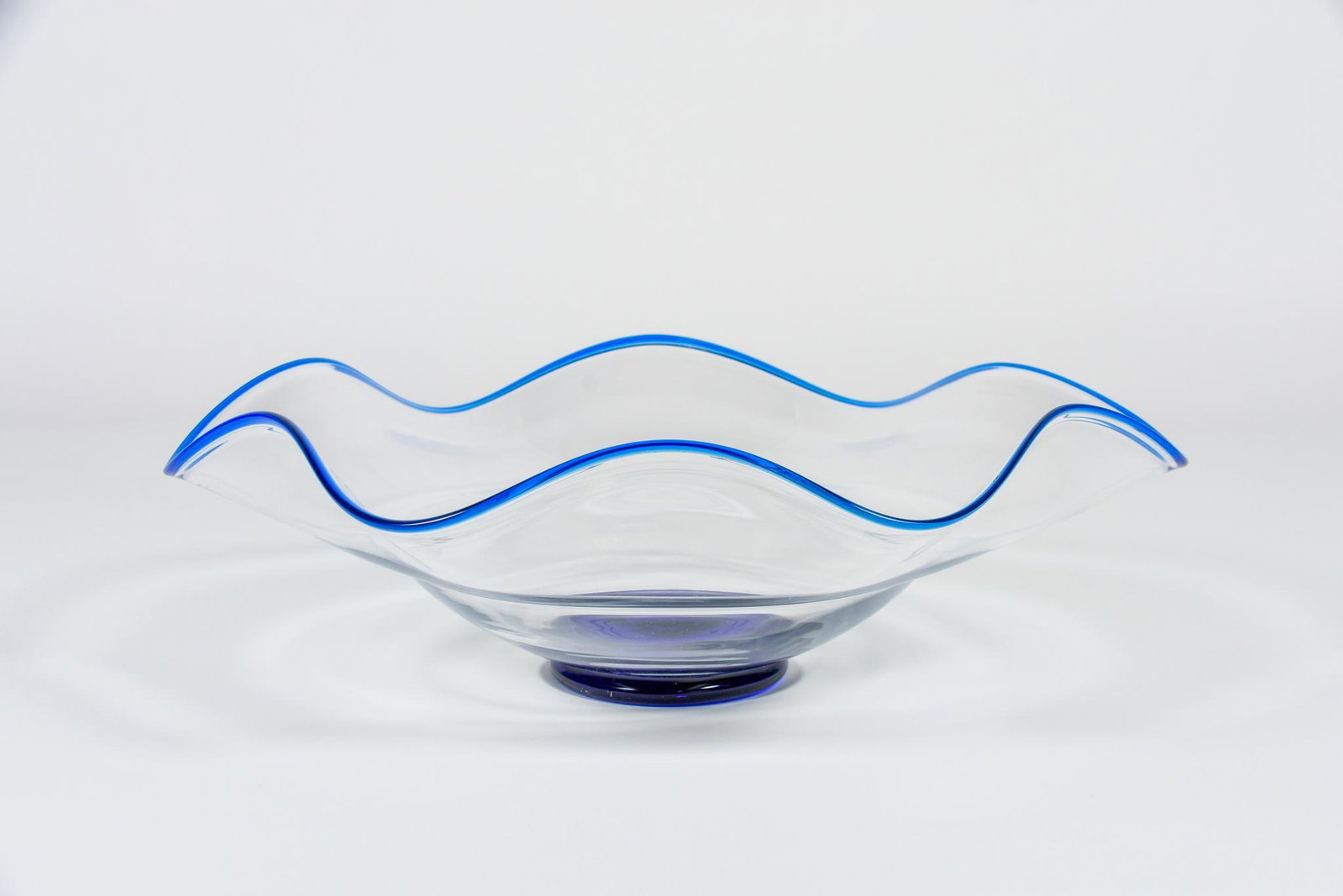 Large Art Glass Wave Bowl With Cobalt Blue Base and Rim: Large Art Glass Wave Bowl With Cobalt Blue Base and Rim. H5.75 x D17 NAVIS Pack and Ship will be handling the shipping of all items from this auction. Go to: http://blockauction.gonavis.com/ for a shi