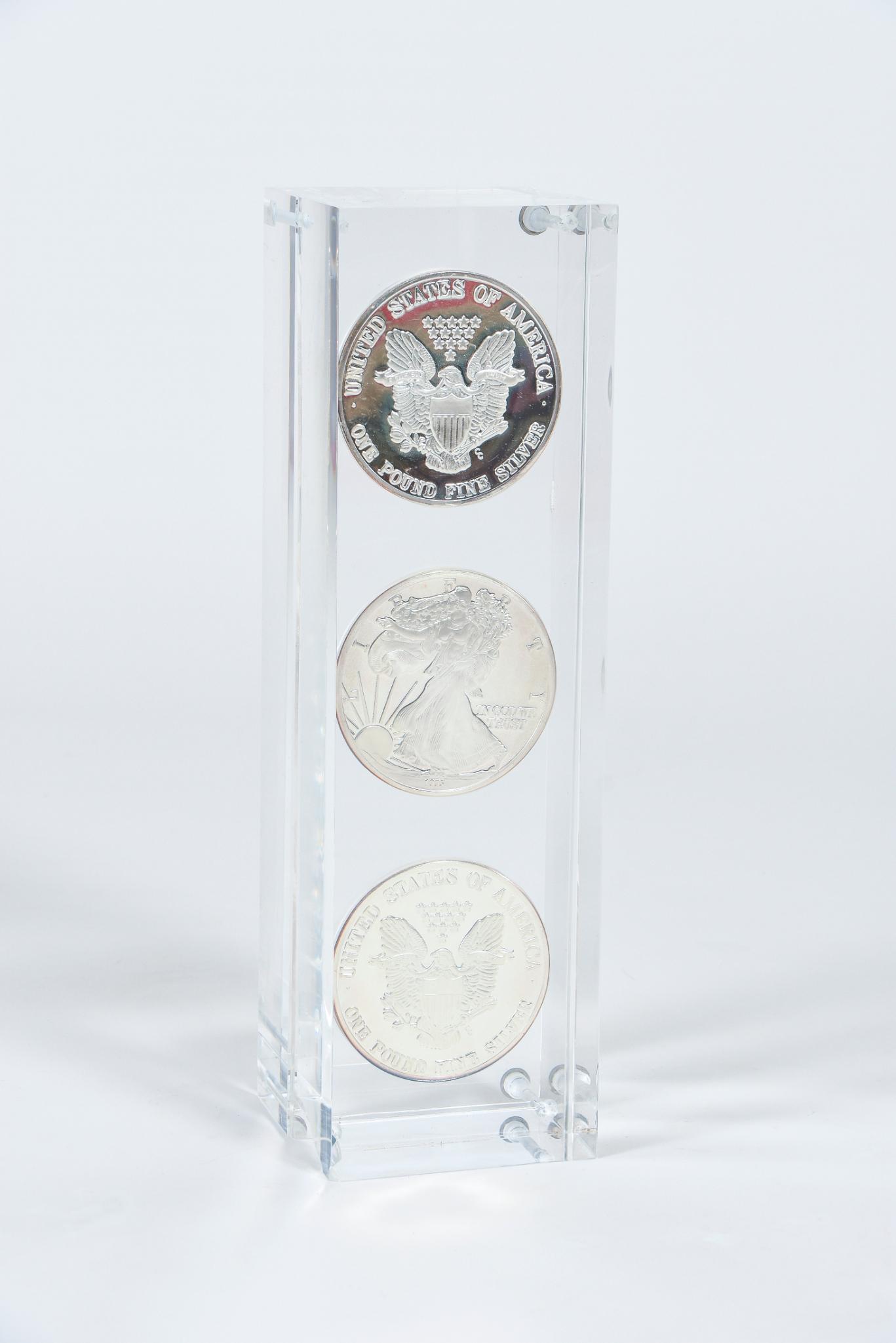 Three 1995 One Pound Fine Silver Coins in Lucite: Three 1995 One Pound Fine Silver Coins in Lucite. H14.5 x W4.25 Coin diameter 3 NAVIS Pack and Ship will be handling the shipping of all items from this auction. Go to: http://blockauction.gonavis.com