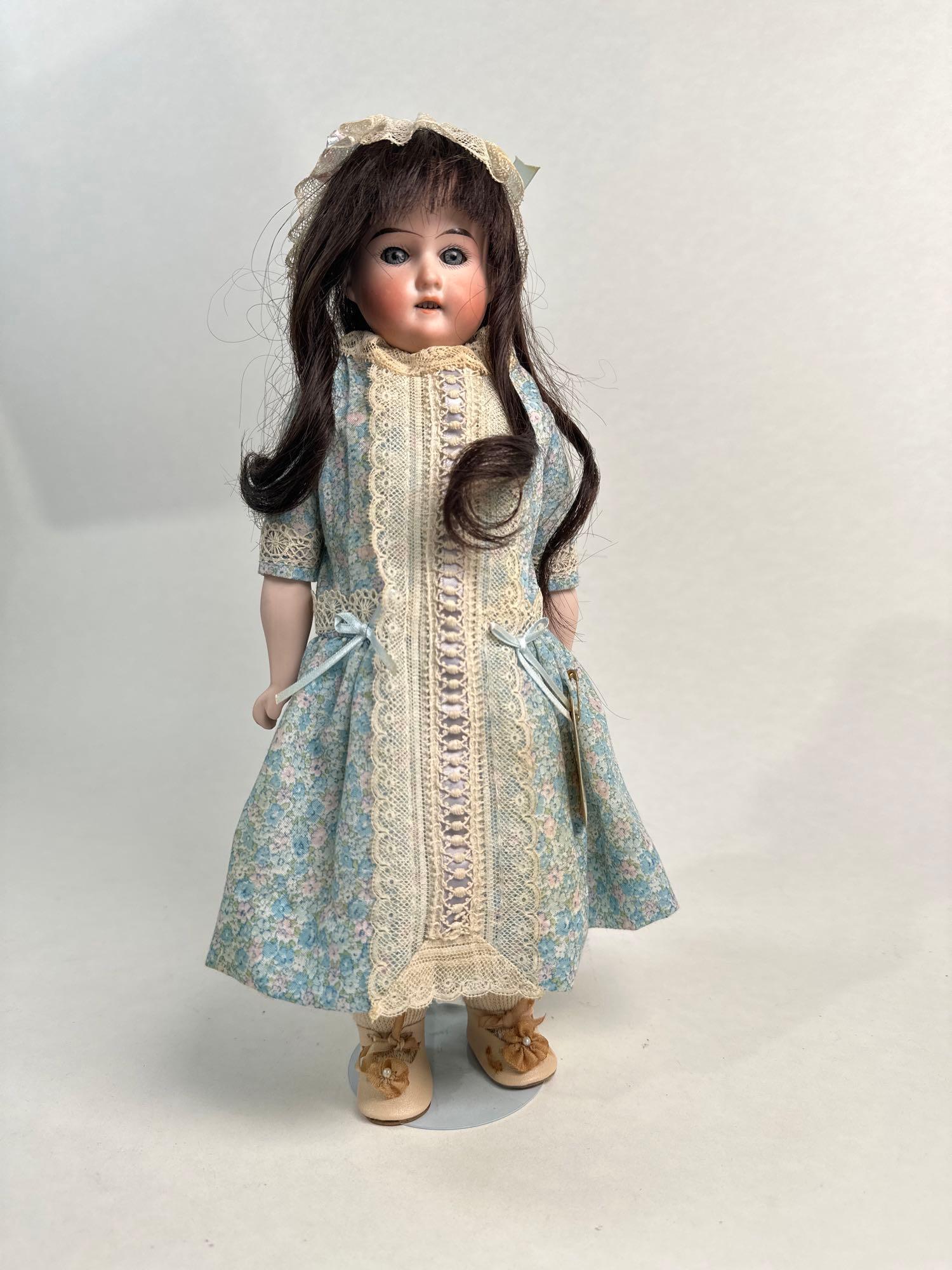 Bisque head doll on cloth body with brown hair and blue flower dress,13.5" doll: Bisque head doll on cloth body with brown hair and blue flower dress, 13.5" doll