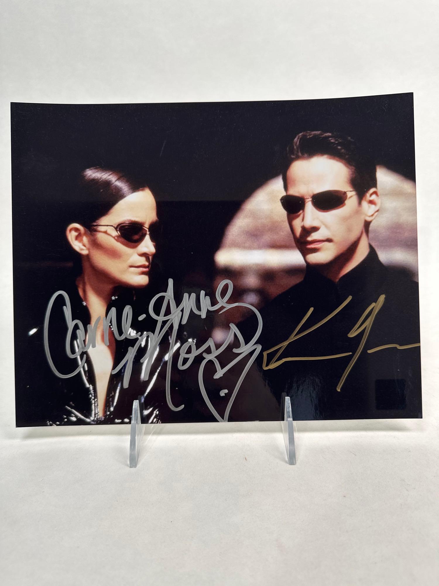 Keanu Reeves and Carrie-Anne Moss sign photo (1 of 10)