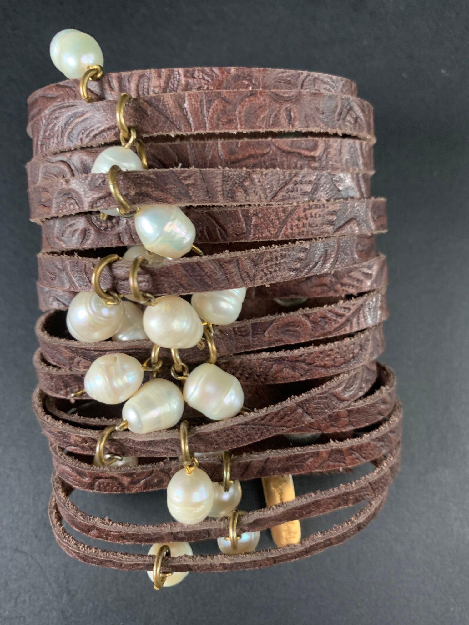 Jenny Rabell leather and Freshwater Pearl Cuff: Jenny Rabell brown embossed leather cuff with baroque pearl charms. Pearls are natural, freshwater pearls. Jenny Rabell charm is located on the cuff for authenticity. Adjustable dual snap closure. Cuf