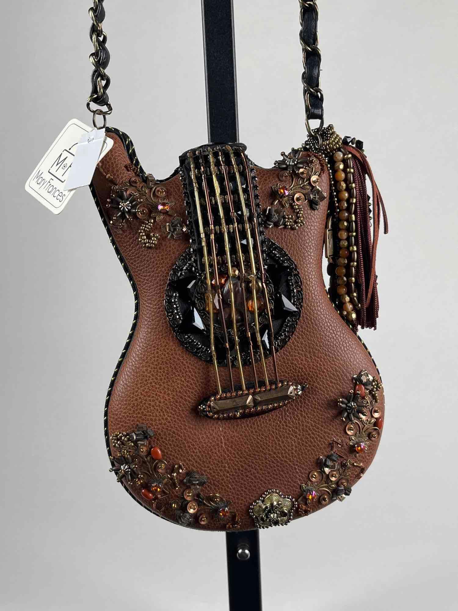 Mary Frances "Hall of Fame" Guitar Purse with Tags: Mary Frances Guitar purse with tags. "Hall of Fame" leather guitar purse embellished with beads, gemstones, chinstrap, and sequins. Inside cell phone pocket and a removable 20" chain. Dime