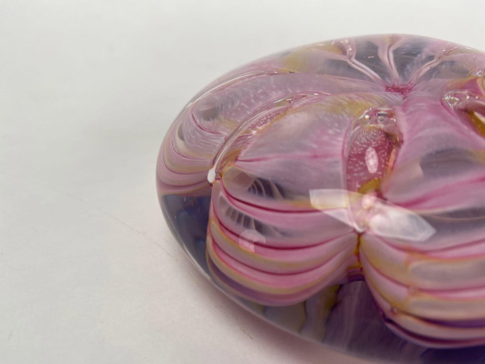 April Wagner and Jason Ruff "Round Pink and Blue" Paperweight (2000): April Wagner and Jason Ruff "Round Pink and Blue Paper Weight" (American, 2000) Pink and lavender hand blown glass with yellow accents. Signature on the bottom of glass. Provenance: Certificat