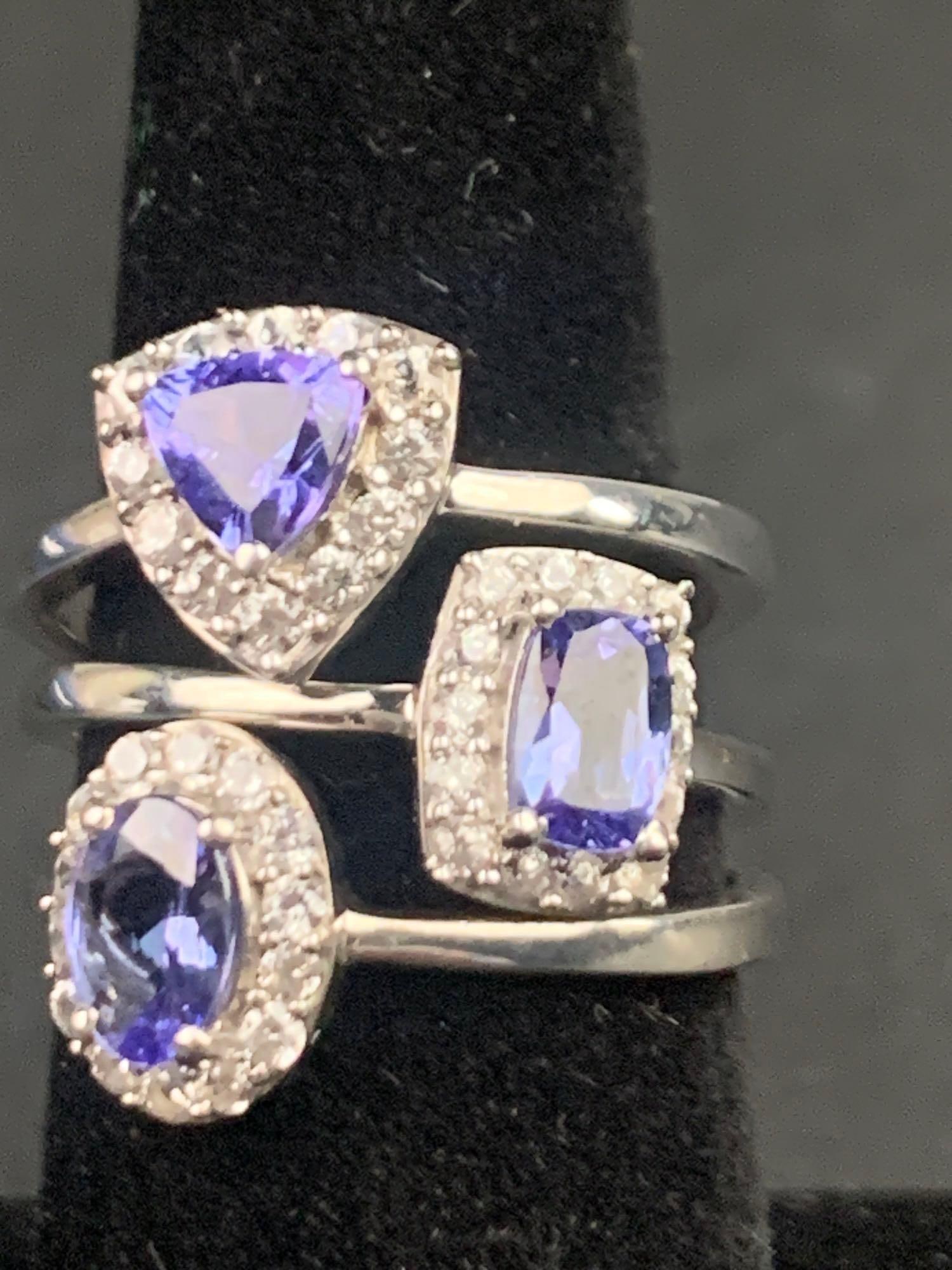 Natural Tanzanite and Zirconia Ring Trio (Platinum over Sterling Silver): 3 tanzanite platinum over sterling silver rings. Rings are all size 9 and between .80-1.10 CTW. All rings are in excellent condition. Please refer to photos for further details. Please note all lots s