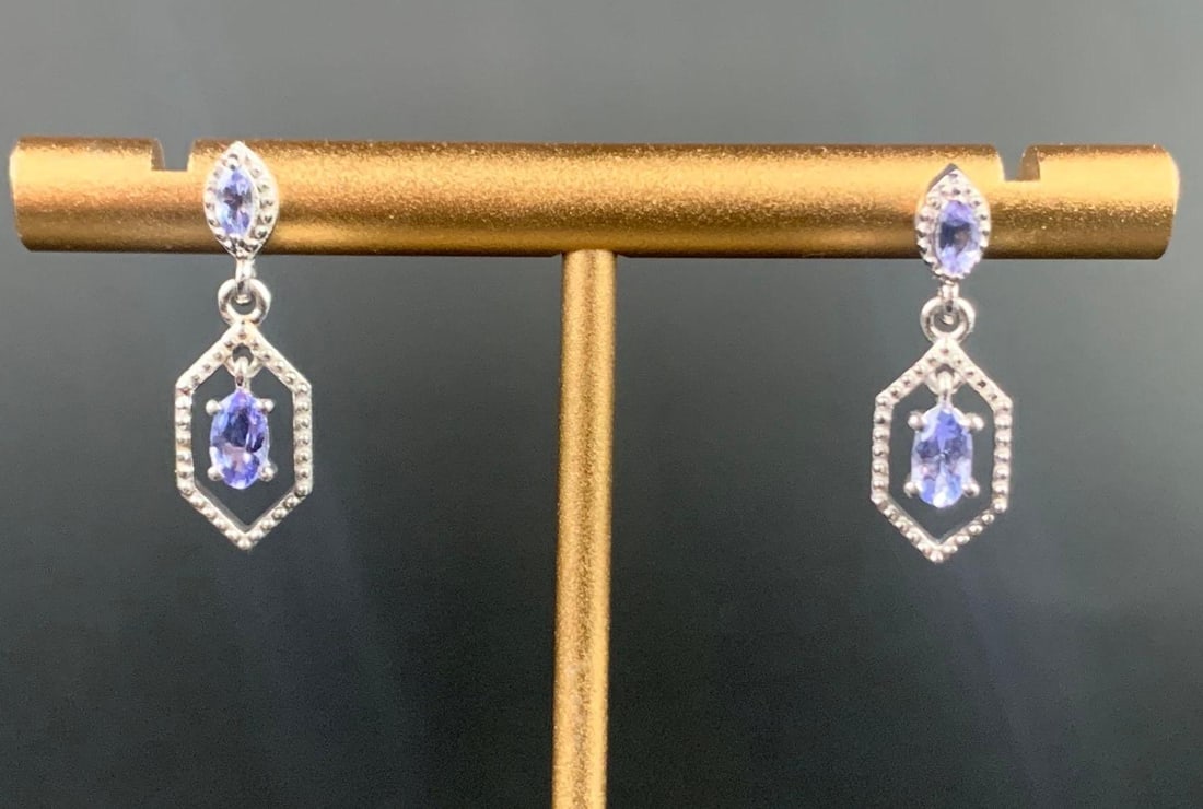 Platinum over Sterling Tanzanite Earrings: Platinum over sterling silver tanzanite earrings. Earrings come in at a total weight of 2.50 grams and are 0.54 CTW. Earrings are in excellent condition. Please refer to photos for further details. Pl