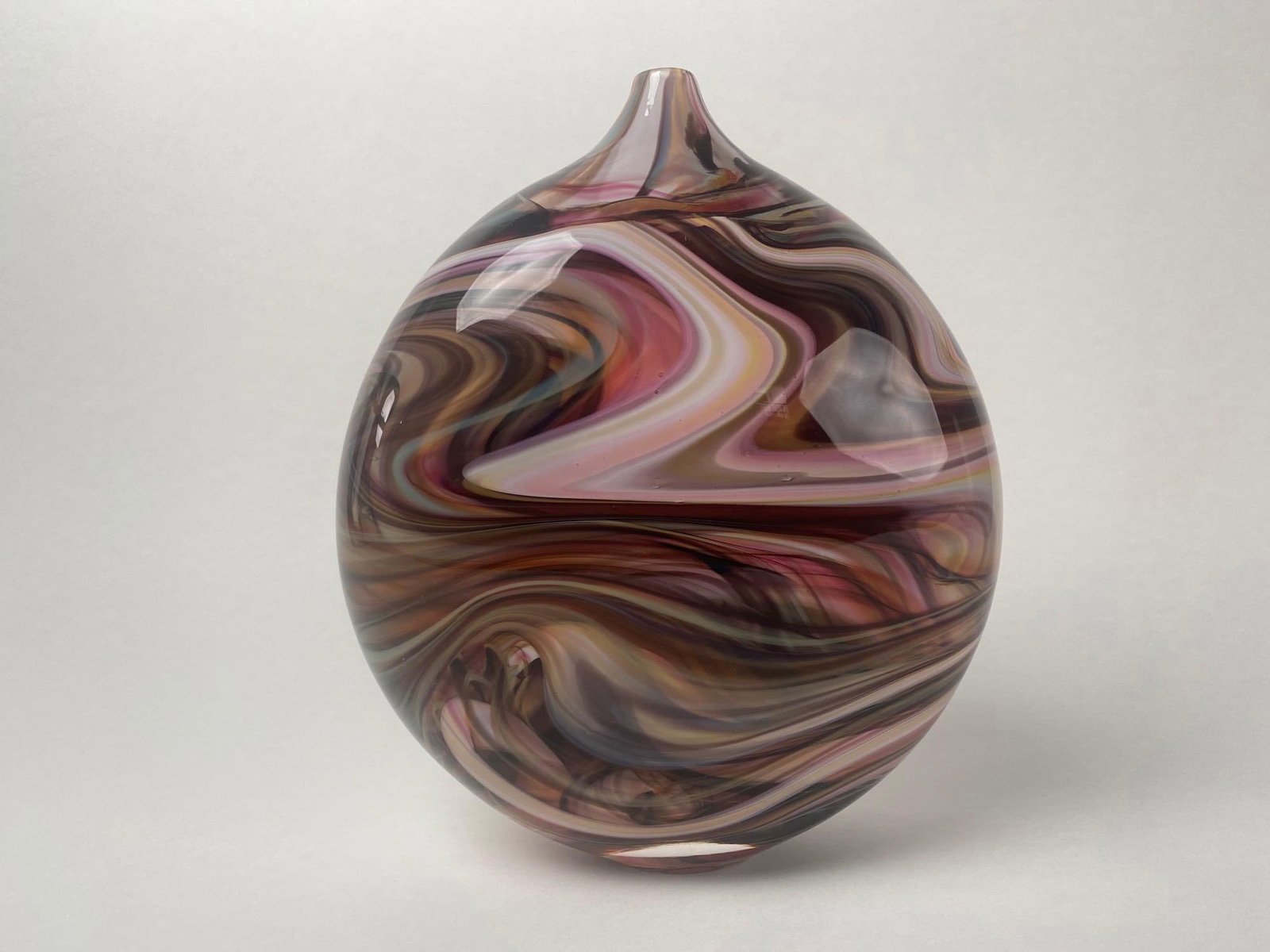 Hand-Blown Art Glass Vase By Delish Glass: Hand-Blown Art Glass Vase produced by Delish Art, glass artists, Jeremy and Chelsea Griffith. This hand-blown vase features a deep color swirl throughout. Signed on the bottom with production date of 
