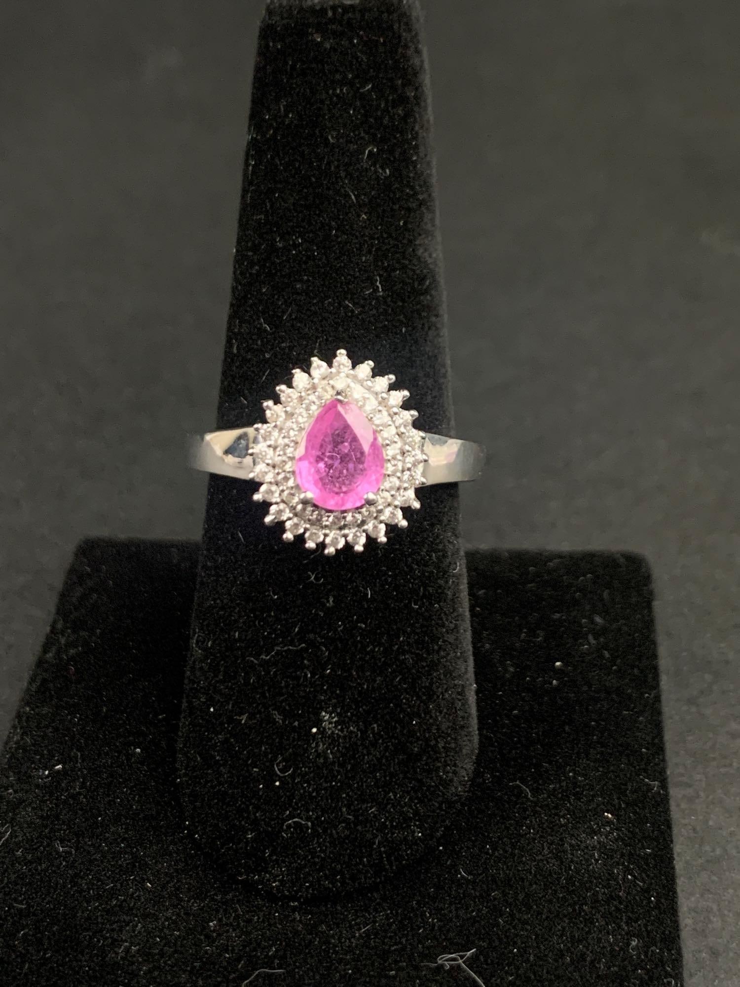 Ilakaka Hot Pink Sapphire Halo Ring: Ilakaka hot pink sapphire platinum over sterling silver halo ring. Ring is size 9 and is 2.08 CTW. Ring is in excellent condition. Please refer to photos for further details. Please note all lots show