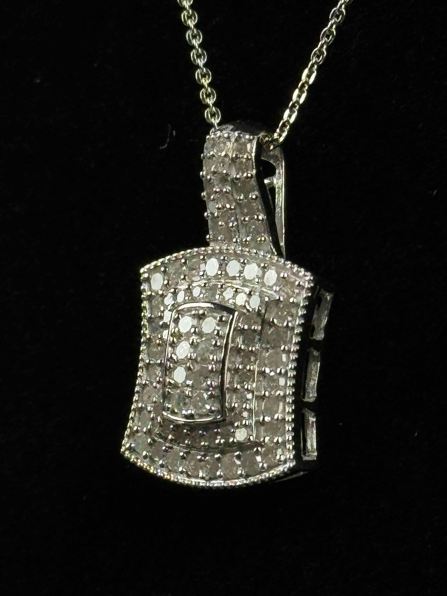 Diamond Cluster Pendant Necklace (1.00 CTW): Sterling silver chain necklace and white diamond pendant. Platinum over sterling. Necklace and pendant come in at a total weight of 5.62 grams, it is 20" and 1.00 CTW. Necklace and pendant are bot