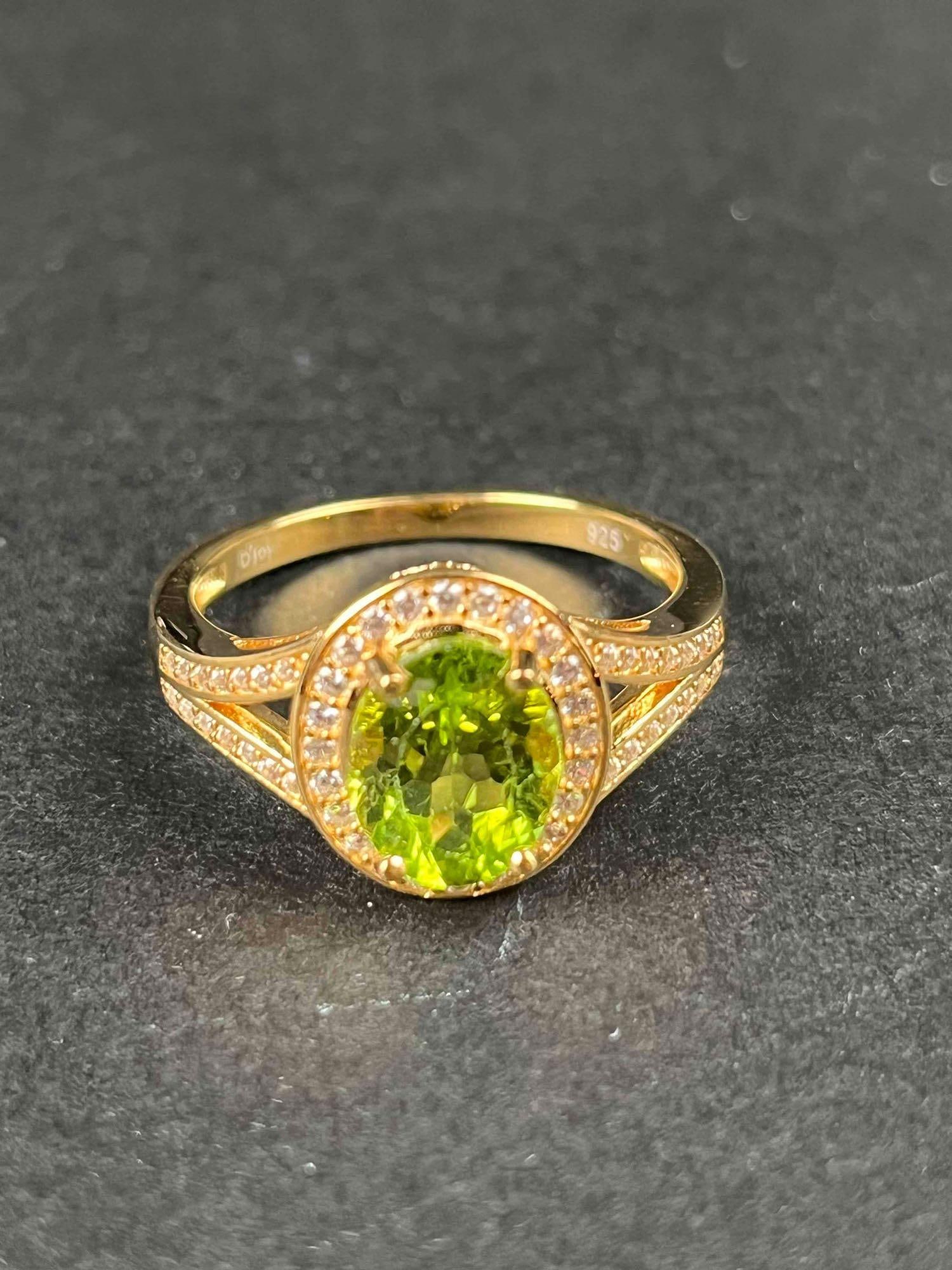 Premium Peridot Natural White Zircon Ring: Premium peridot natural white zircon plated sterling silver ring. Ring is size 10 and is 3.25 CTW. Ring is in excellent condition. Please refer to photos for further details. Please note all lots show