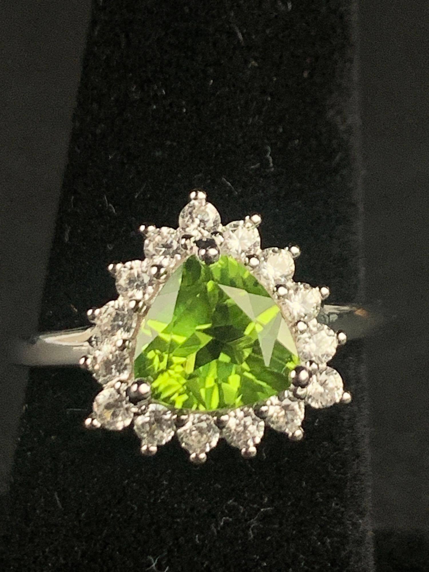 Premium Peridot Natural White Zircon Halo Ring: Premium peridot natural white zircon and sterling silver halo ring. Ring is size 8 and is 2.65 CTW. Ring is in excellent condition. Please refer to photos for further details. Please note all lots sho