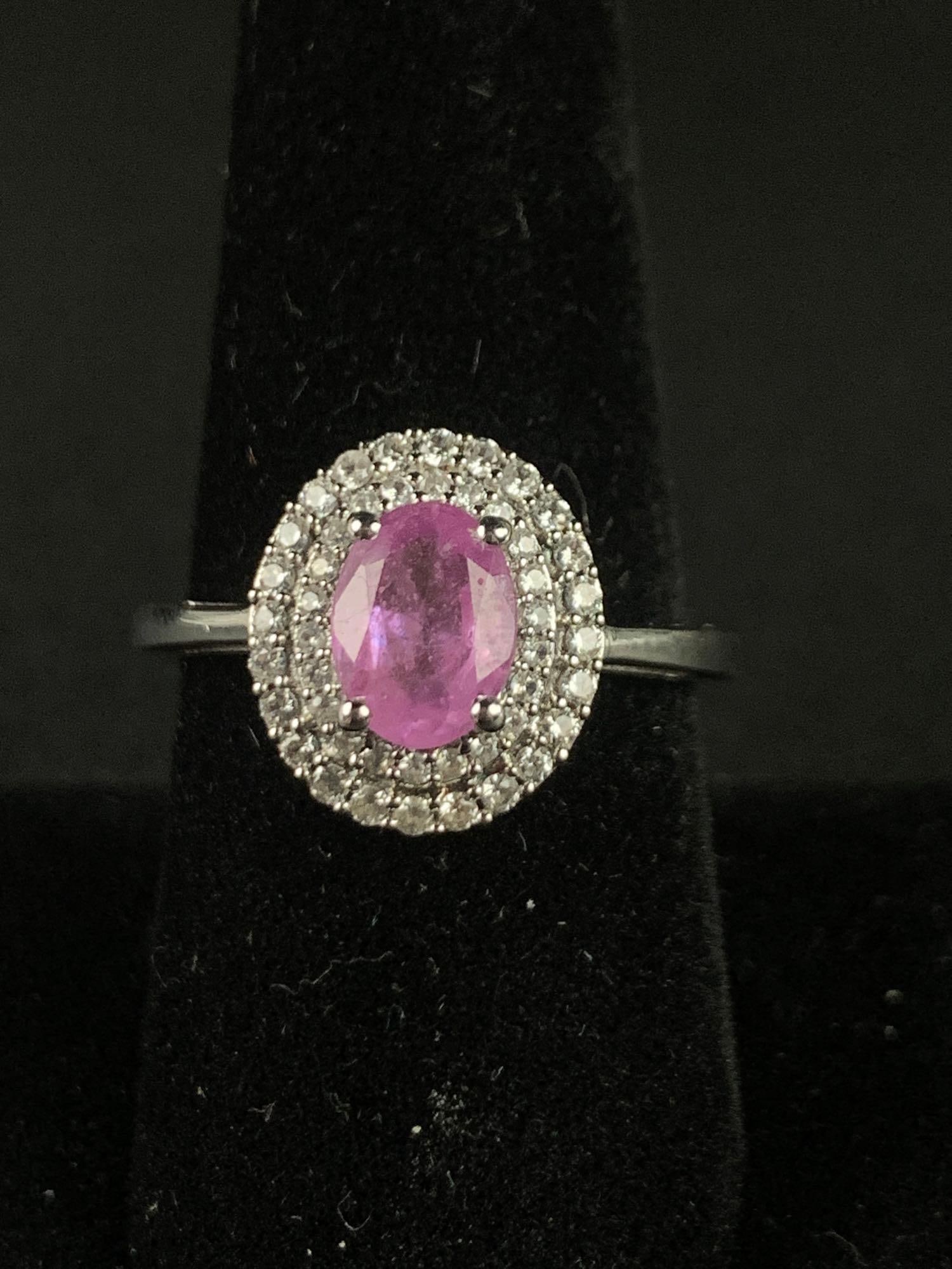 Ilakaka Hot Pink Sapphire and Zircon Halo Ring: Ilakaka hot pink sapphire platinum over sterling silver halo ring. Ring is size 9 and is 2.30 CTW. Ring is in excellent condition. Please refer to photos for further details. Please note all lots show