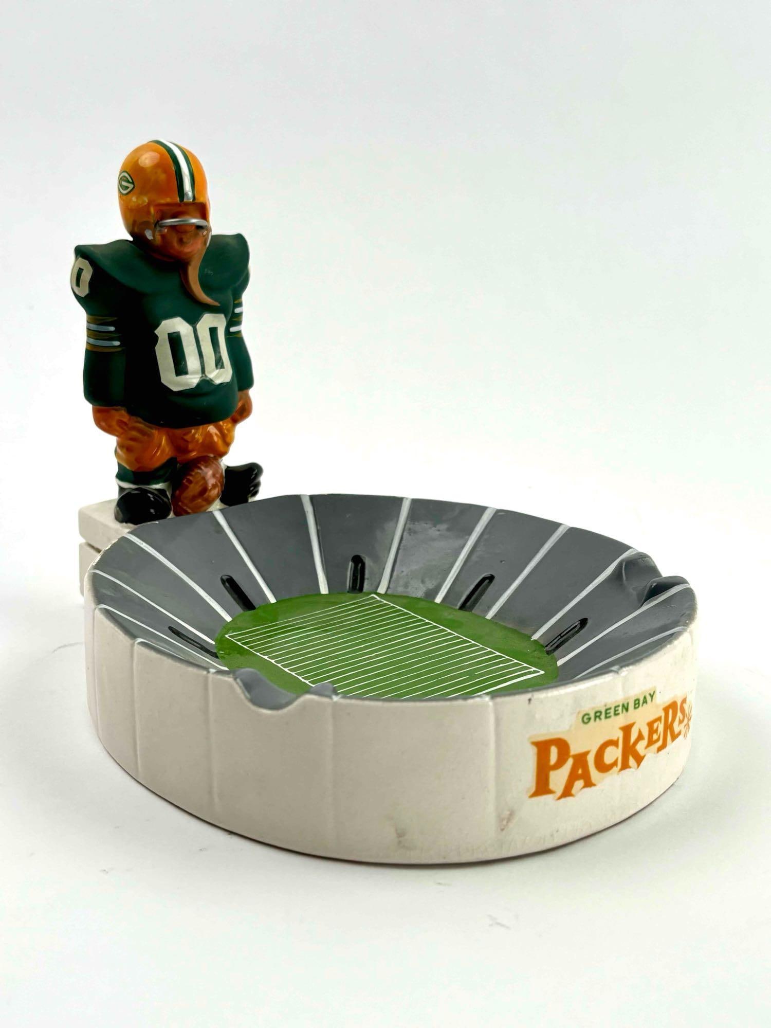 Rare 1950's Fred Kail Green Bay Packers Football Stadium Ashtray: Rare 1950's Fred Kail Green Bay Packers Football Stadium Ashtray. The ashtray is in the shape of an old-time football stadium and has a small standing lineman at the foot of the tray. The figure has n
