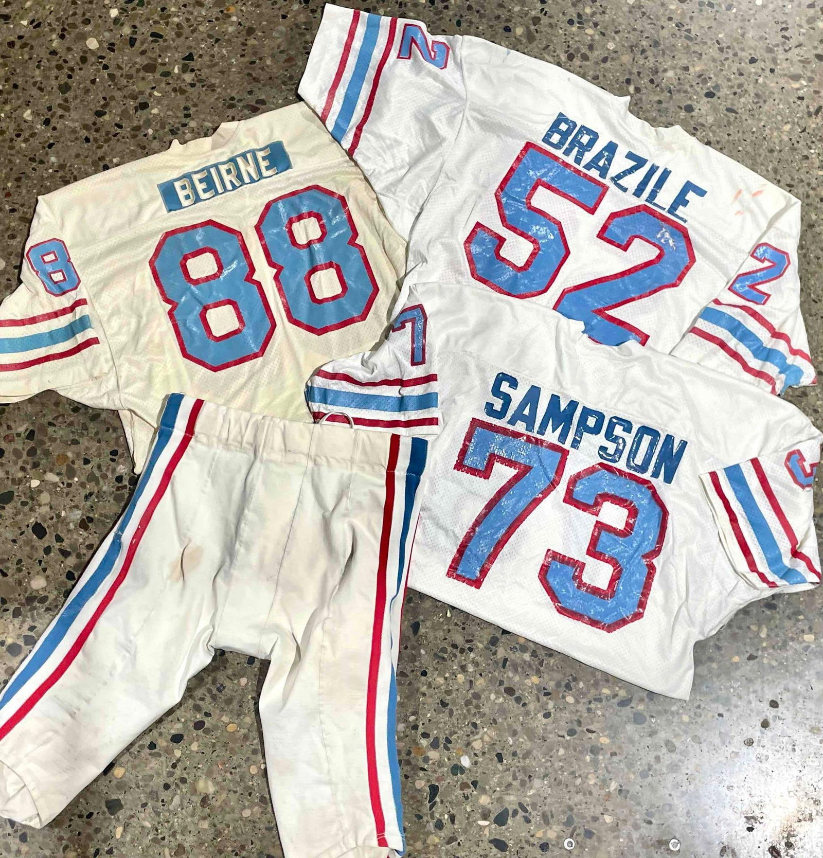 Houston Oilers Uniforms (Jim Beirne, Robert Brazile, Greg Bingham, Greg Sampson): Assorted Houston Oilers uniforms including a Jim Beirne jersey, Robert Brazile jersey, Greg Bingham pants, and a Greg Sampson jersey. Please see photos for additional details. Please note all lots sho