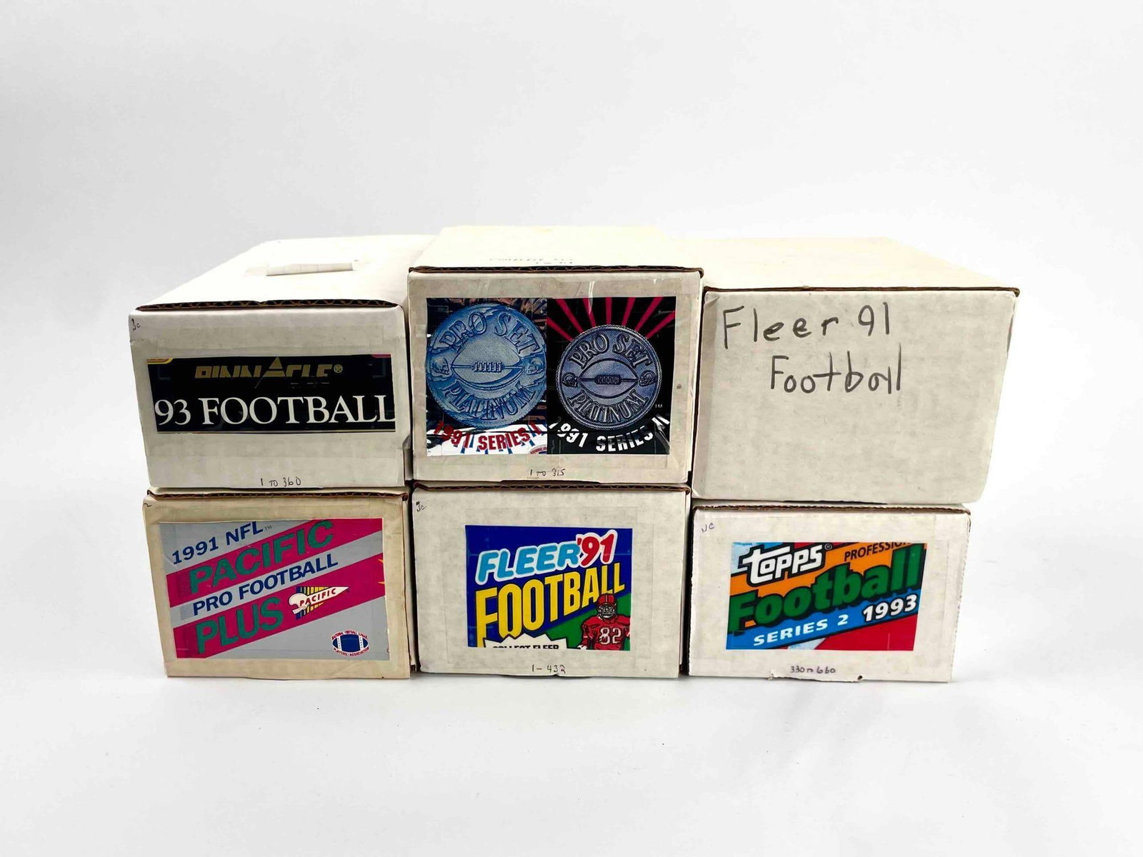 1990s Football Cards (Pinnacle, Pacific, Fleer, Pro Set Platinum, Topps): Seven boxes of football cards from the 90s. Cards include Pinnacle, Pacific, Fleer, Pro Set Platinum, and Topps. Please see photos for additional details. Boxes include: One 1993 Pinnacle One 1991 NFL