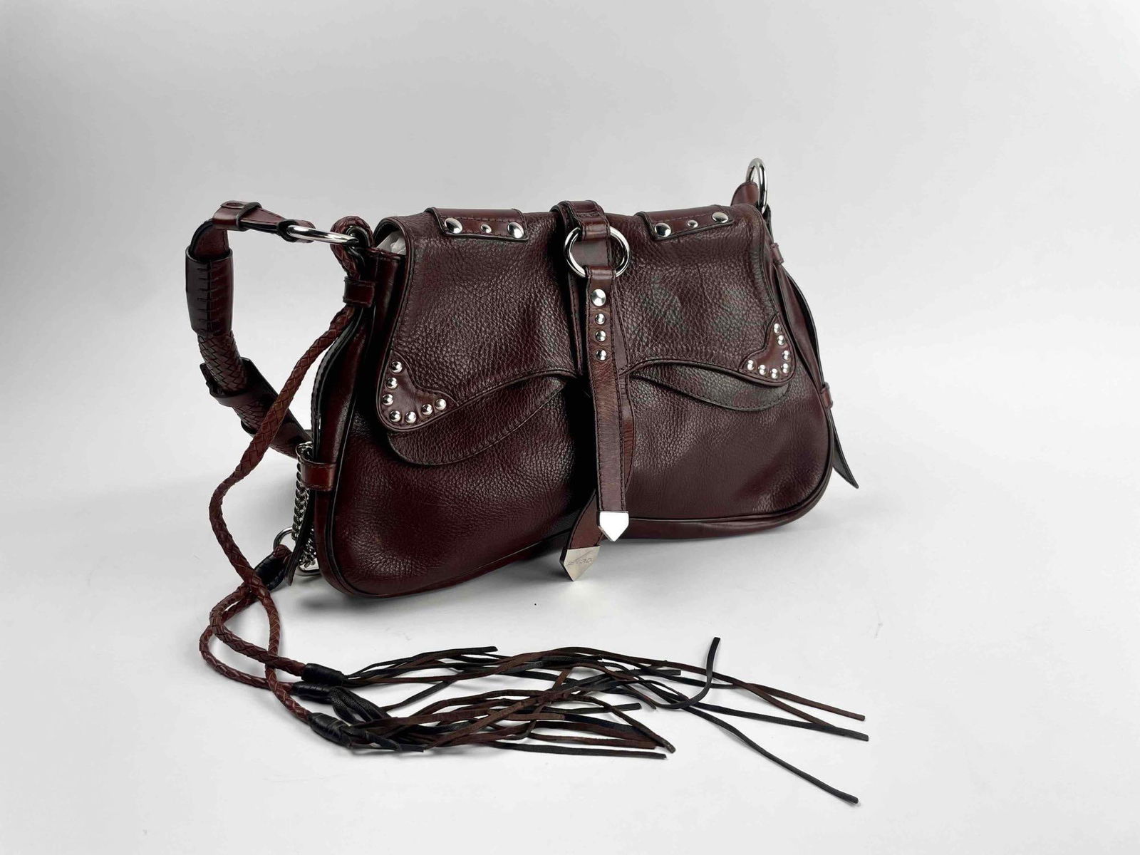 Etro Brown Leather Handbag with Fringe Detail: Etro Brown Leather Handbag with fringe detail and a royal blue lining. Hardware is in silver tone with a magnetic clasp. Handbag is in excellent condition with minimal signs of wear and use. Please se