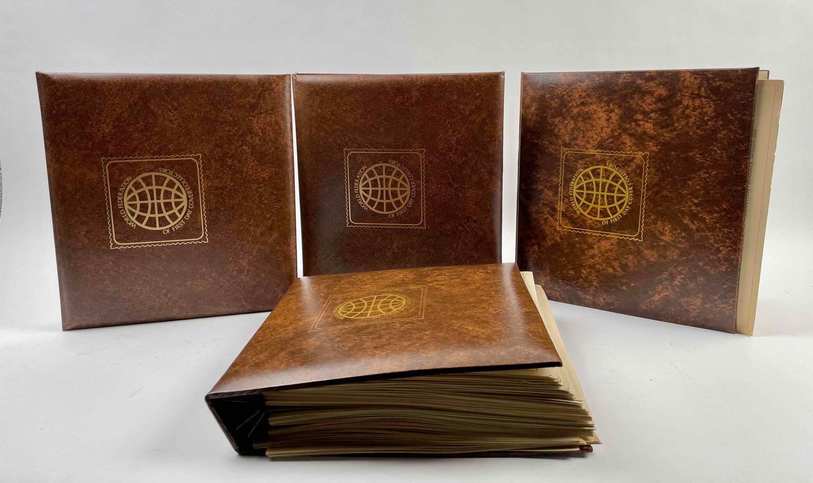 Four "World Federation of First Day Covera" Collectors Albums: Four World Federation of First Day Cover Collectors albums. In excellent to fair condition. One book has pages loose from the binding but can be reattached. Please see photos for additional details. W