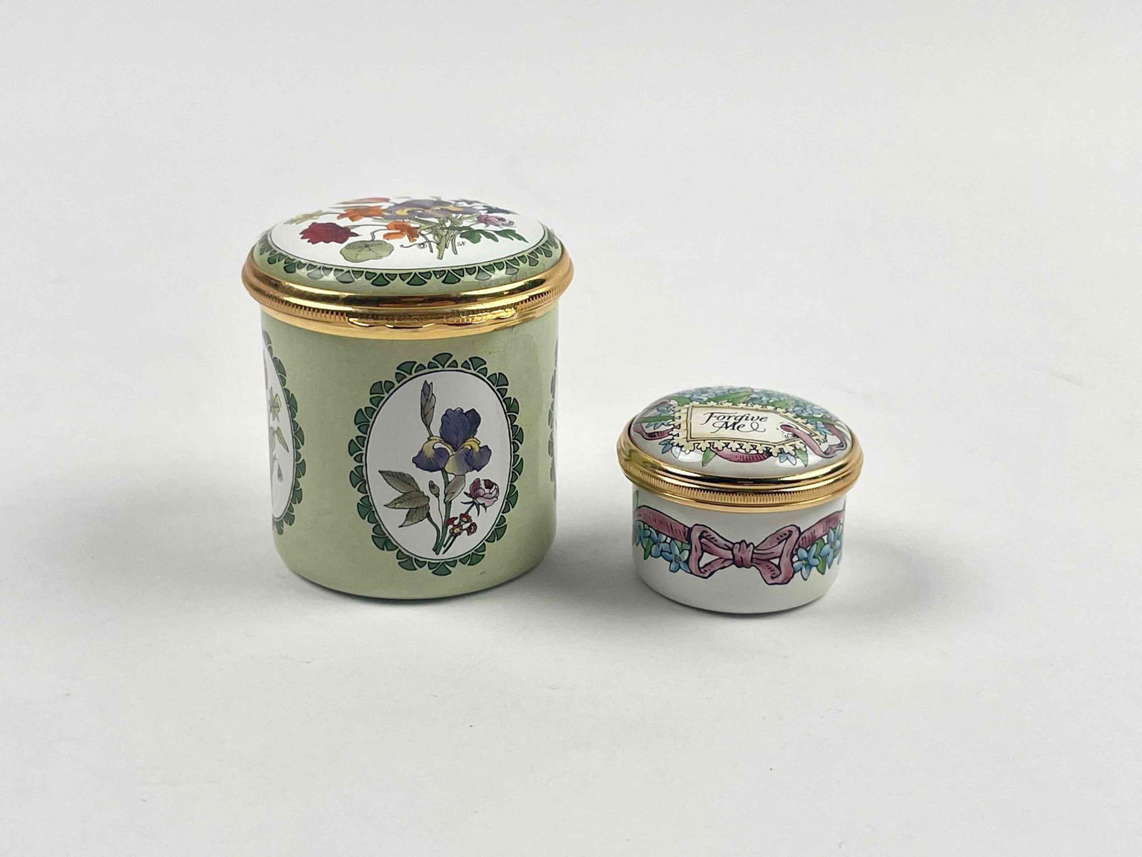 Pair of Hand Painted Enamel Pill Boxes (Halcyon Days): Pair of Halcyon Days hand painted enamel pill boxes. Both boxes come in their original packaging and are in excellent condition. Please see photos for additional details. Dimensions Small: 1" x 1.25"