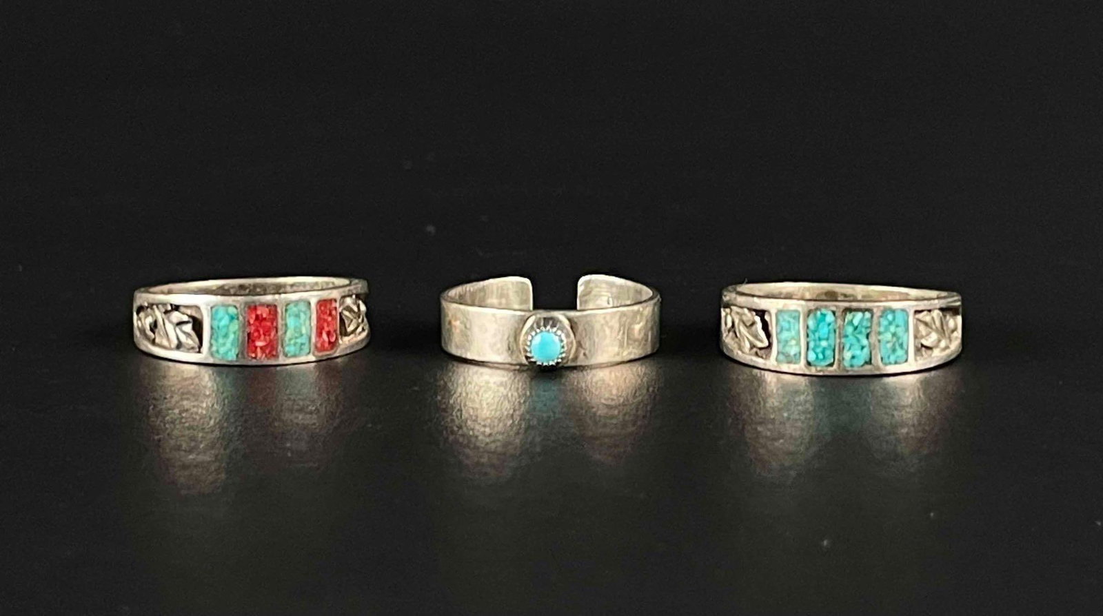 Trio of Sterling Silver Rings: Three sterling silver rings. Rings are inlaid turquoise and coral. Third ring is free size and has a turquoise bezel setting. Please see photos for additional details. Ring Size Inlayed Stones: 10.5 R