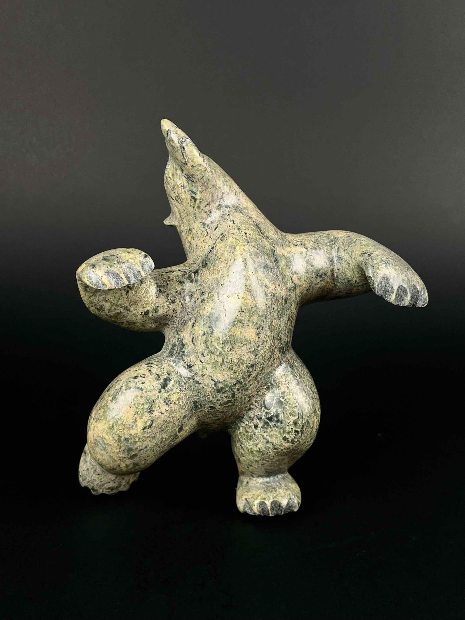 Inuit Carved Dancing Bear (Cape Dorset/Kinngait): Inuit Soapstone dancing bear carving. Polished stone. Piece is signed in Inuktitut syllabics on the foot. This piece was purchased in Cape Dorset/Kinngait directly from the artist by collector Jon Jac