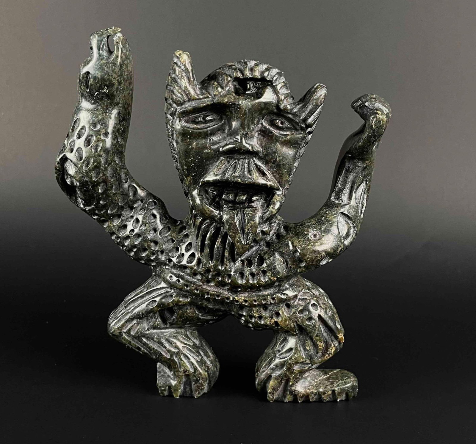 Large Inuit Spirit Carving (Tytoosie Tunnillie, Cape Dorset/Kinngait): Large dark green serpentine Inuit spirit carving. Polished stone. Piece is signed in Inuktitut syllabics on the foot by Tytoosie Tunnillie. This piece was purchased directly from the artist in Cape Do