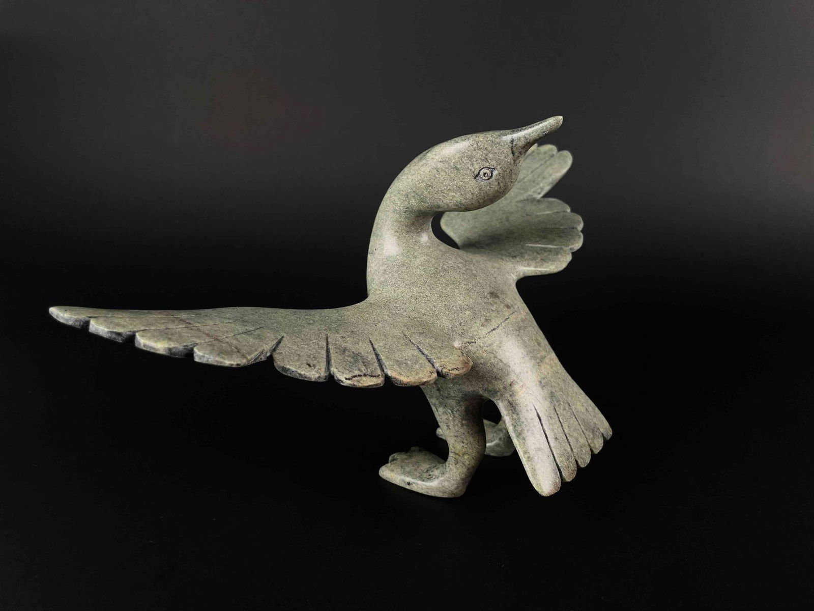 Inuit Soapstone Goose Carving (Cape Dorset/Kinngait): Inuit reclining goose sculpture in green soapstone. Body is polished stone. This piece is unsigned but is numbered on the foot as pictured. (S437, 99) This piece was purchased on Cape Dorset/Kinngait,