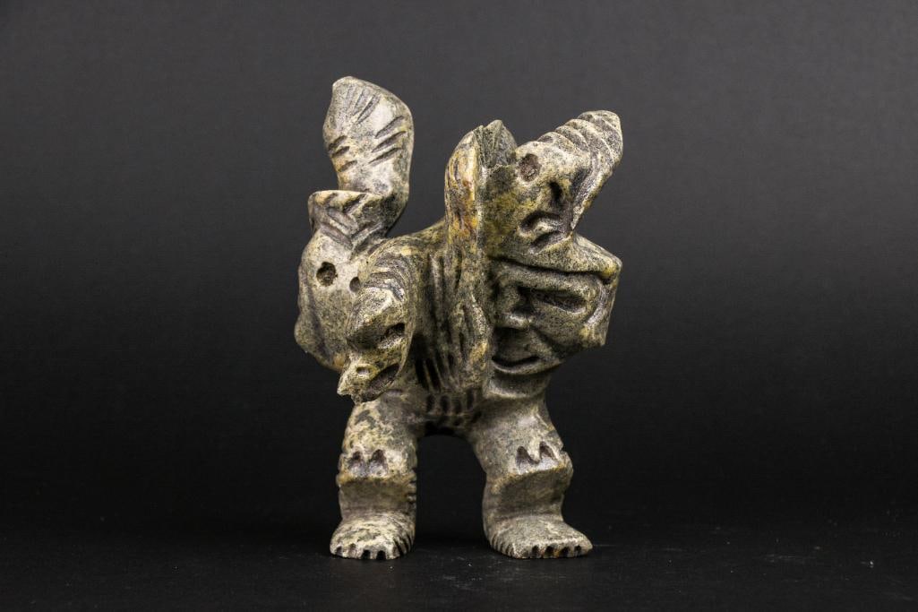 Inuit Spirit Carving in Green Soapstone (Tytoosie Tunnillie, Cape Dorset/Kinngait): Inuit abstract spirit carving. Polished soapstone. Piece is signed in Inuktitut syllabics on the foot by Tytoosie Tunnille. This piece was purchased directly from the artist in Cape Dorset/Kinngait by