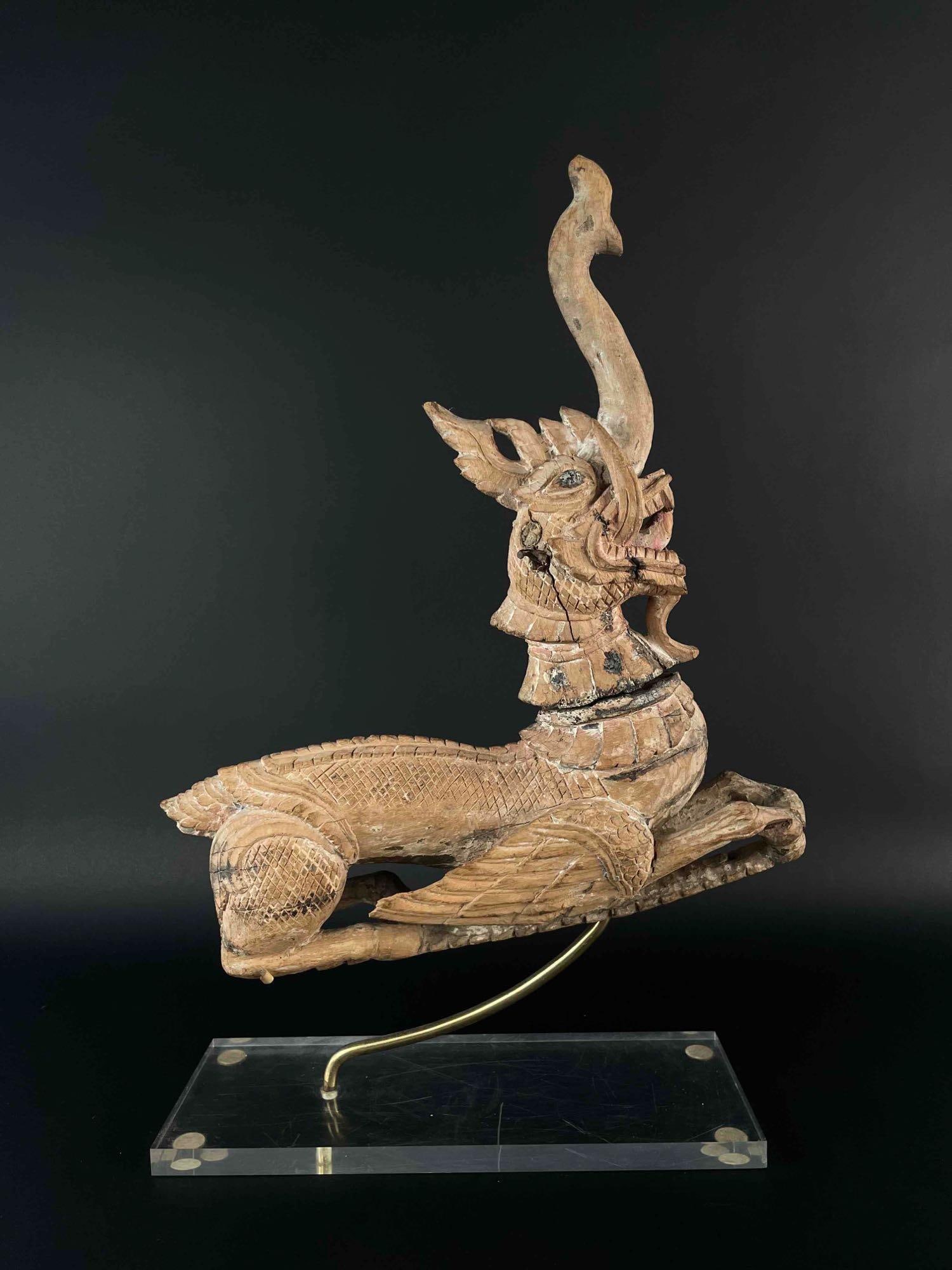 Thai Wood Carving (19th Century): 19th century wooden carving of a dragon. Purchased in Bangkok,Thailand at Neold Collection. Copy of receipt is included. Carving is set on a lucite stand. Cracks are present in the wood as pictured. F