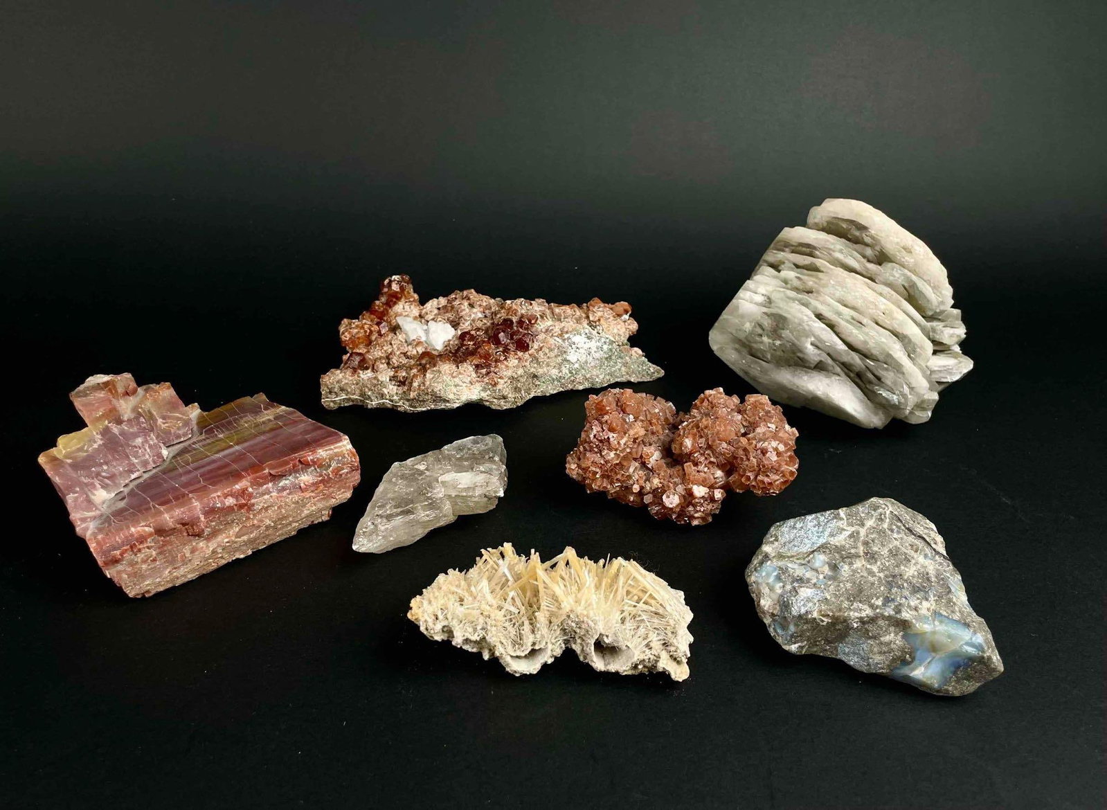 Assortment of Geological Specimens (Garnet, Aragonite, Colorless Opal, Jasper, Quartz, Crystals): Assortment of 1 Garnet with Diopside, 1 Aragonite, 1 Colorless Semi-precious Stone, 1 slab of Jasper, 1 Quartz, and 1 Crystal specimen. All specimens are in good condition. Some may have natural wear 