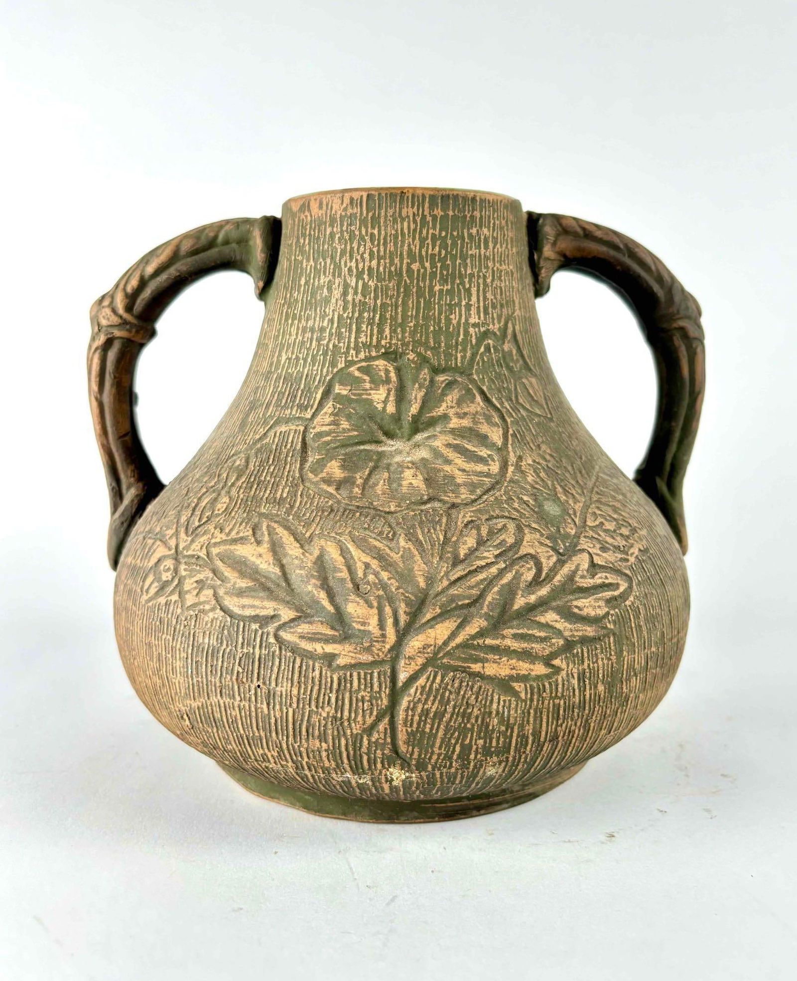 Green Red Wing Union Stoneware Co. Brushware Vase: Red Wing Union Stoneware Company Brushware vase. Vase is green and features 2 handles on each side and a floral design in front and center. Inside of vase has a green glaze. Hallmark is stamped on bot