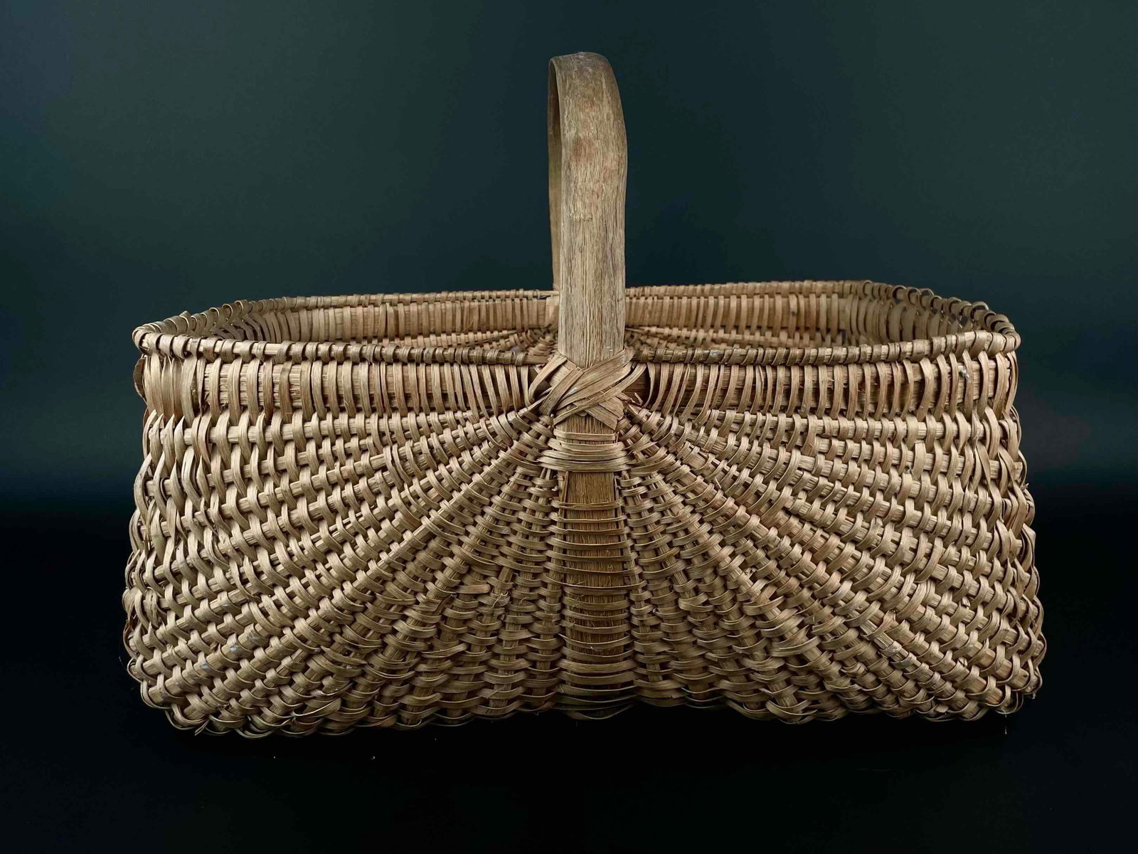 Hand Woven Basket with Handle: Woven basket with handle. In good condition with signs of wear that are consistent with age and use, such as small areas of fraying and discoloration. Please see photos for additional details. From th