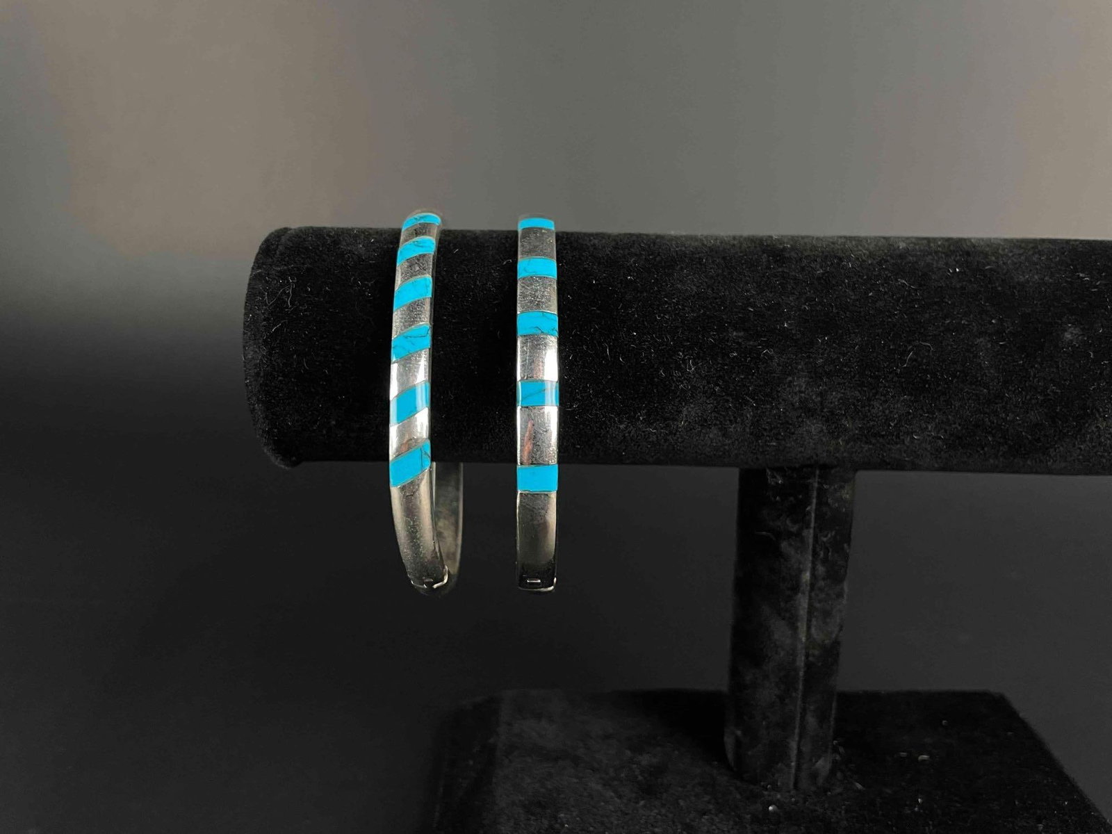 Pair of Sterling Silver and Turquoise Bracelets (Made in Mexico): Pair of sterling silver and turquoise bangle bracelets. 925 and "Mexico" hallmarks are incised in inner band. Bracelet opens and closes. In good condition. Please see photos for additional det
