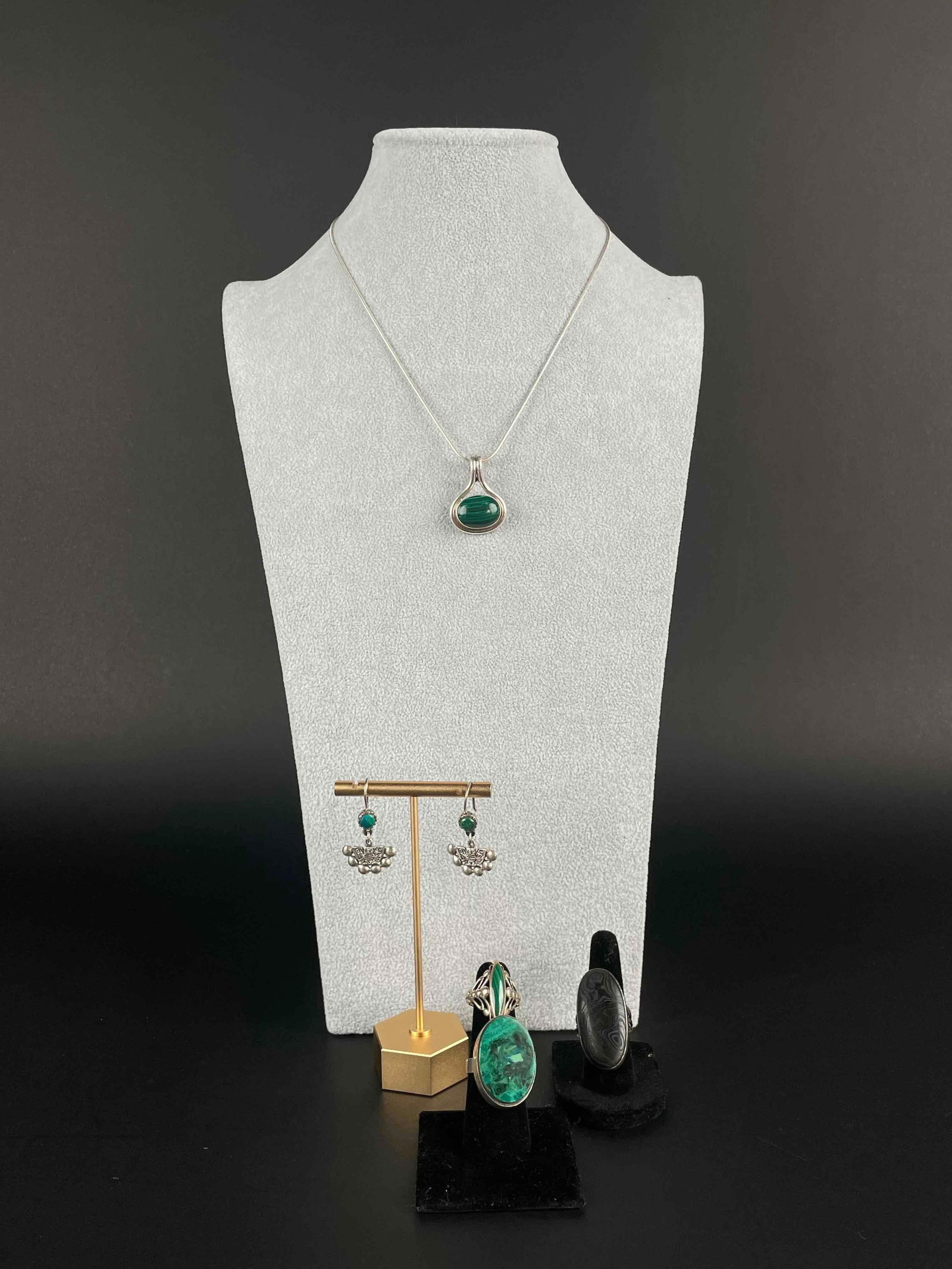 Malachite Set with Psilomelane Ring: Assorted malachite jewelry and psilomelane ring. Includes: 2 malachite rings set in sterling silver 1 malachite necklace set in sterling silver with sterling silver chain Pair of malachite sterling