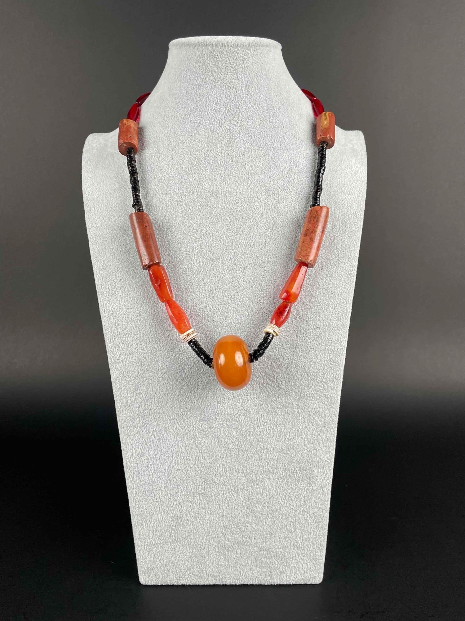 Multicolor Beaded Necklace with Bakelite: Multicolor beaded necklace with large bakelite bead at center. In excellent condition. Please see photos for additional details. Length: 24.5" Weight: 101.56 g Please note all lots show signs o