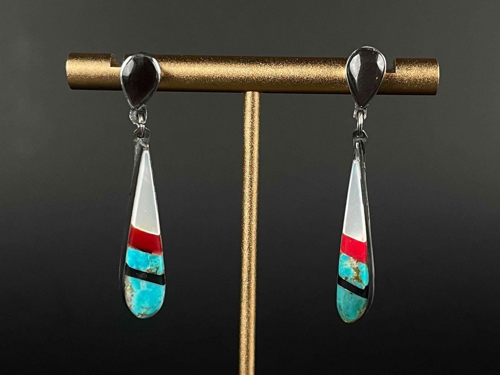 Zuni Sterling Silver Turquoise Multistone Inlay Earrings: Zuni inlay earrings made of Turquoise, Coral, Jet, and Mother of Pearl set in Sterling Silver. In excellent condition. Please see photos for additional details. Length: 1.75" Weight: 5.5 g Please 