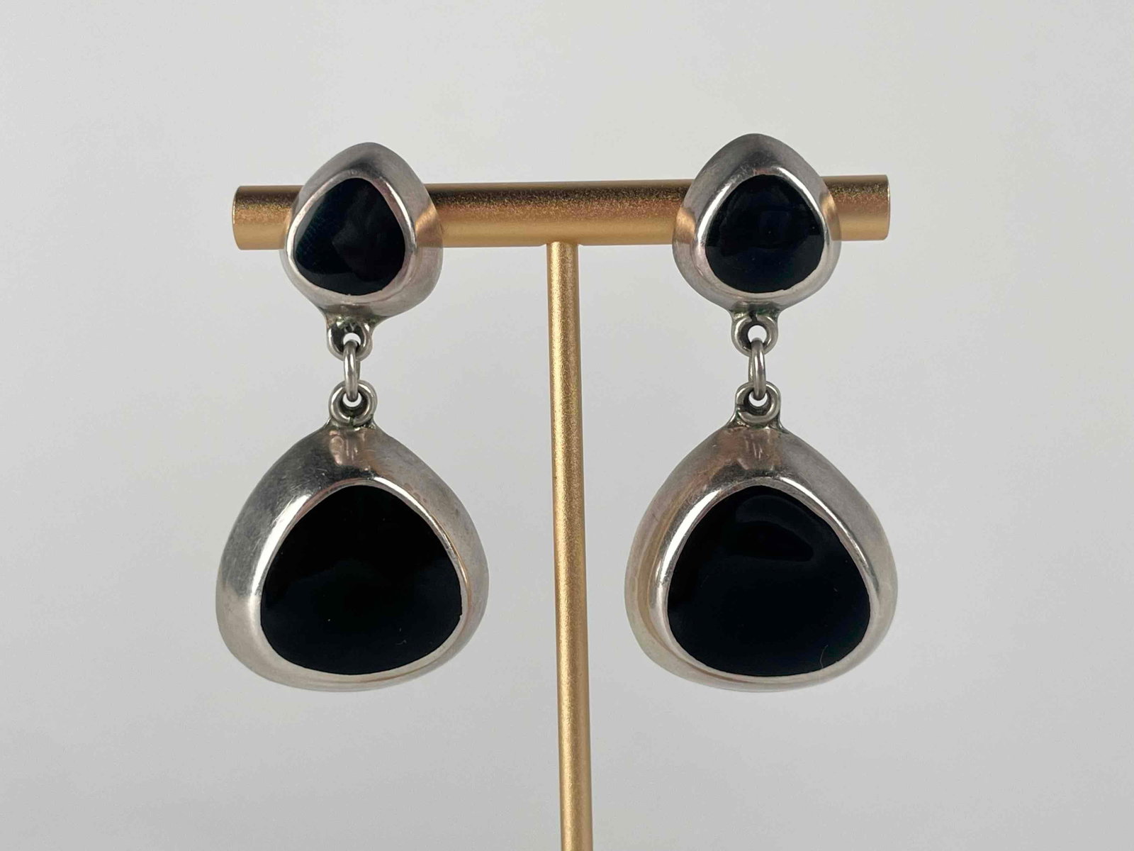 Sterling Silver and Onyx Earrings (Made in Mexico): Sterling silver and Onyx earrings. "Mexico TM-12 925" is engraved on back of pendant. In excellent condition. Please see photos for additional details. Dimensions: 2" x 1" Weight: 20.7