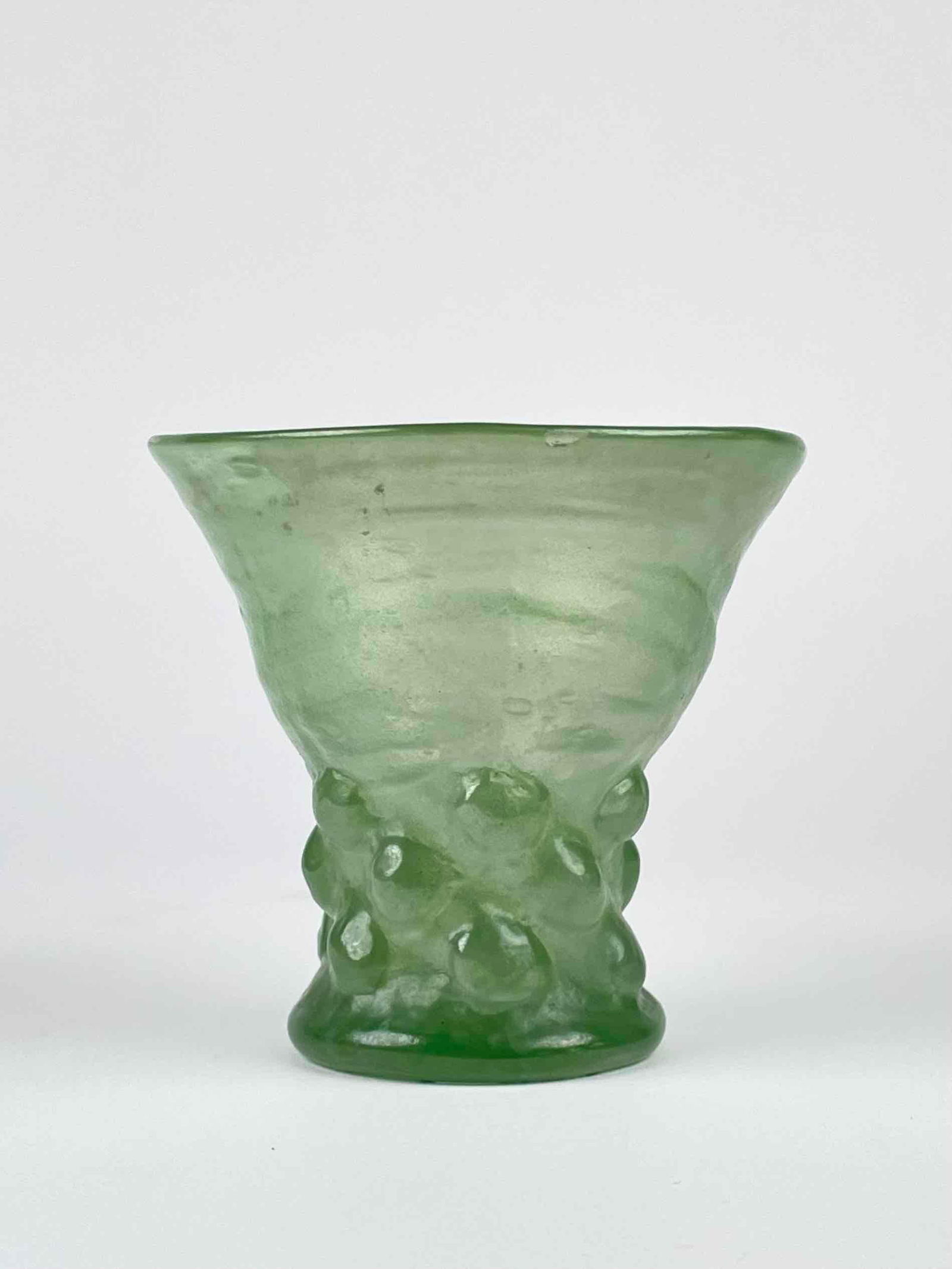 German Prunted Glass Goblet: Prunted glass goblet. Light green in color. Features a wide mouth. From the home of Jon Jacobs, a prominent collector in Michigan. In good antique condition with signs of wear that are consistent with