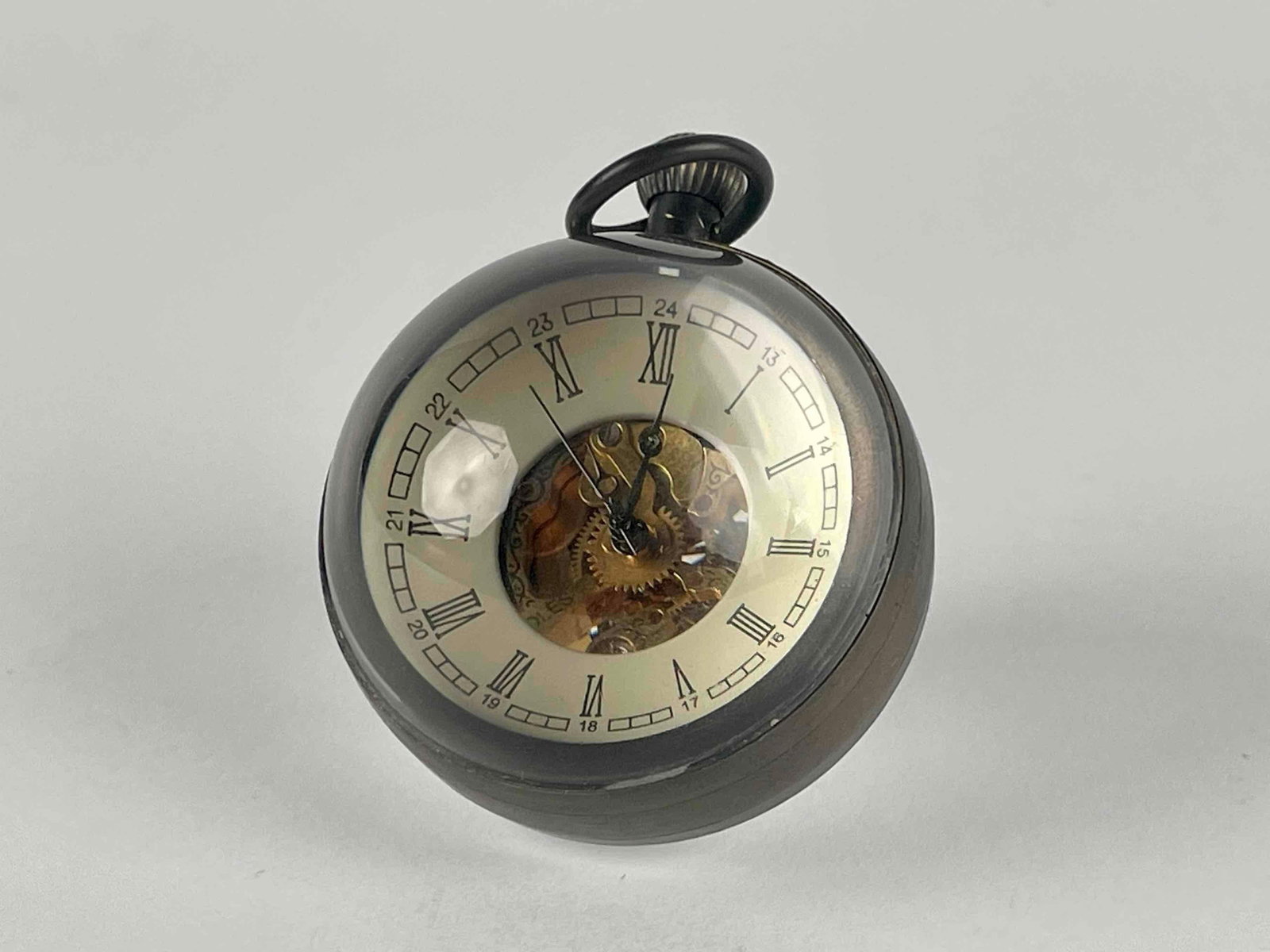 17 Jewels Glass Ball Clock (Louxong, RCLES): 17 jewels glass ball clock with open face and open back. Crystal and brass exterior. Winder is located on top of clock under handle. 17 Jewels hallmark is located on open back. Louxong and RCLES is in