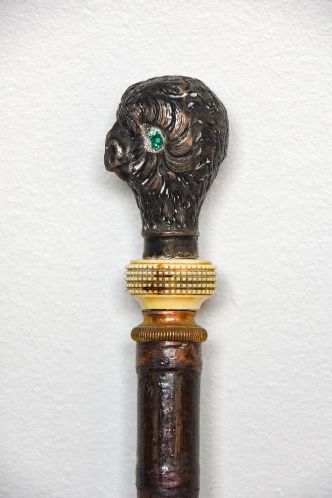 Antique Sterling Owl Figural Cane: Antique Sterling silver and owl figural collectors cane with bone collar. Emerald colored rhinestone eyes and brass hardware detail. "U" is marked on the top of the shaft as pictured. Cane is in good