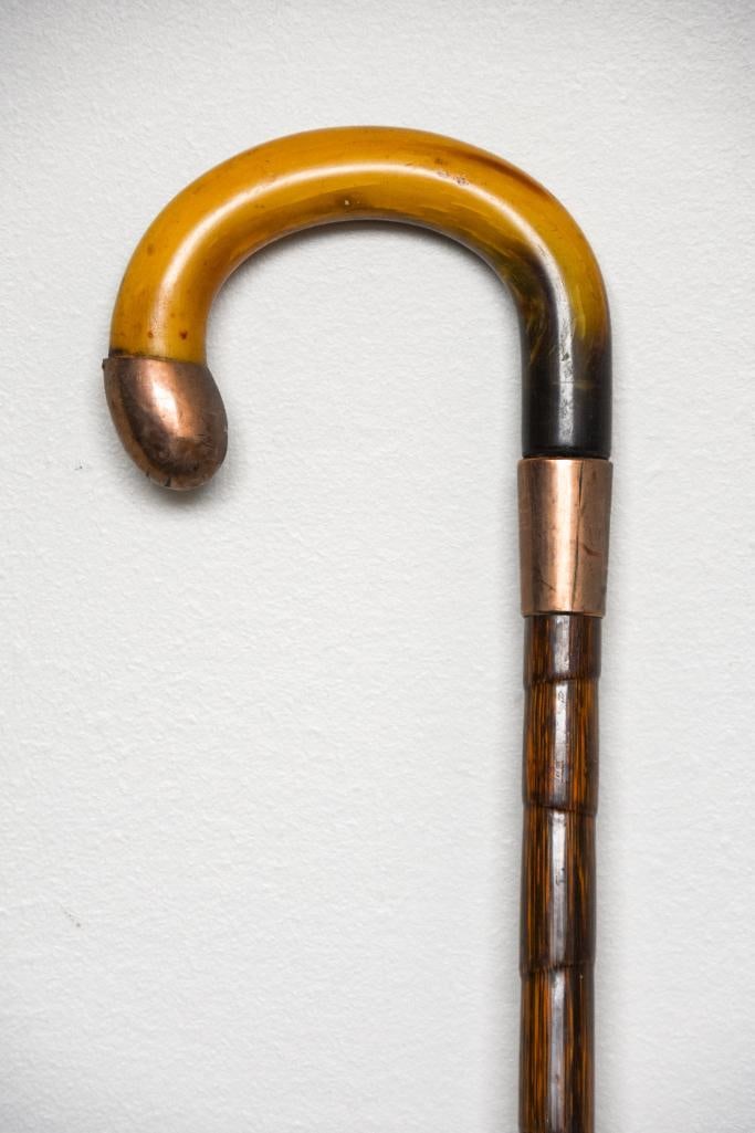 Antique 10k Gold and Carved Horn Walking Stick: Antique carved horn walking stick in 10K gold trim. Stick is engraved "H.T.B" as a monogram. 375 M stamped on the gold as pictured. Piece has been gold tested. Wood appears to be bamboo. Please see ph