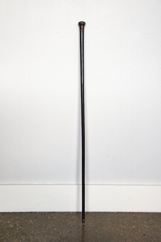 Sterling Silver and Ebonized Wood Walking Stick: Sterling silver ebonized antique walking stick. Walking stick is showing considerable signs of wear. The shaft has cracked towards the bottom of the cane. It is still in one piece and in tact. Please 