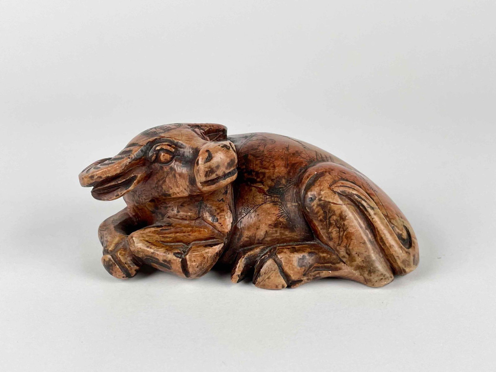 Chinese Bull Stone Carved Stamping Seal: Chinese stone carved stamping seal in the shape of a bull with landscape design on back and Chinese characters on head. From the home of Jon Jacobs, a prominent collector in Michigan. Dimensions: 5.5"
