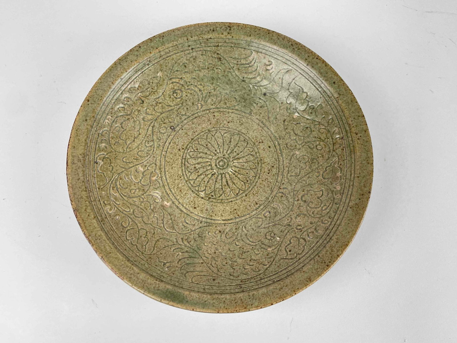 Earthenware Bowl with Floral Motif: Earthenware bowl with engraved floral motif and green glaze. From the home of Jon Jacobs, a prominent collector in Michigan. Bowl is in good condition with light crazing and surface wear in some areas
