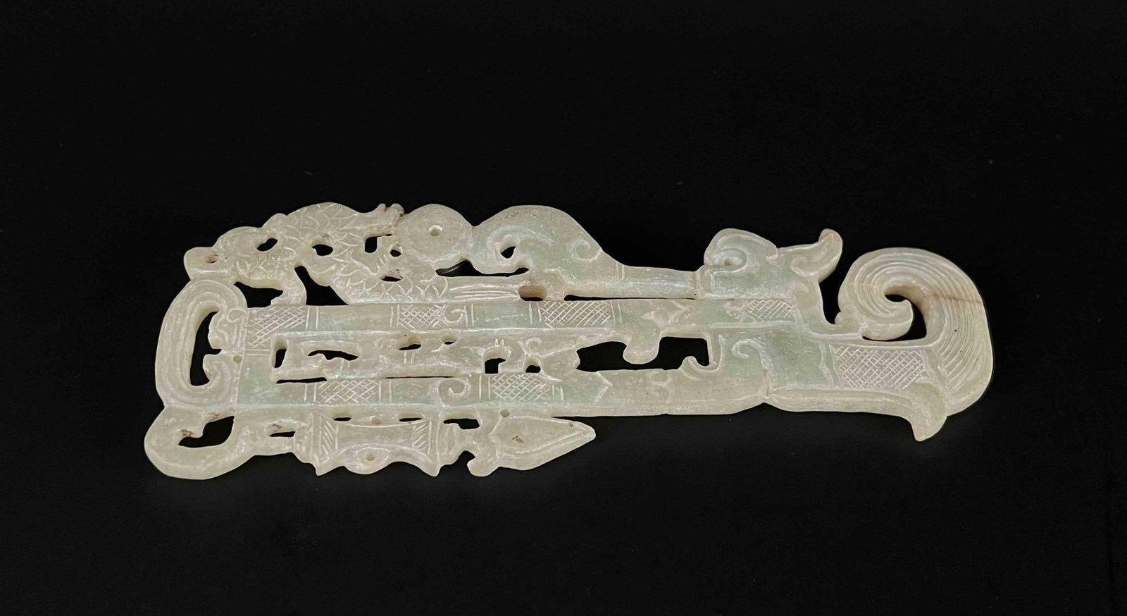 Chinese Jade Carved Pendant: Chinese Jade carved pendant with engraved detailing. Light green jade. Carving depicts a dragon figure, spearhead, and other patterns. From the private collection of Mr. Jon Jacobs, a prominent collec