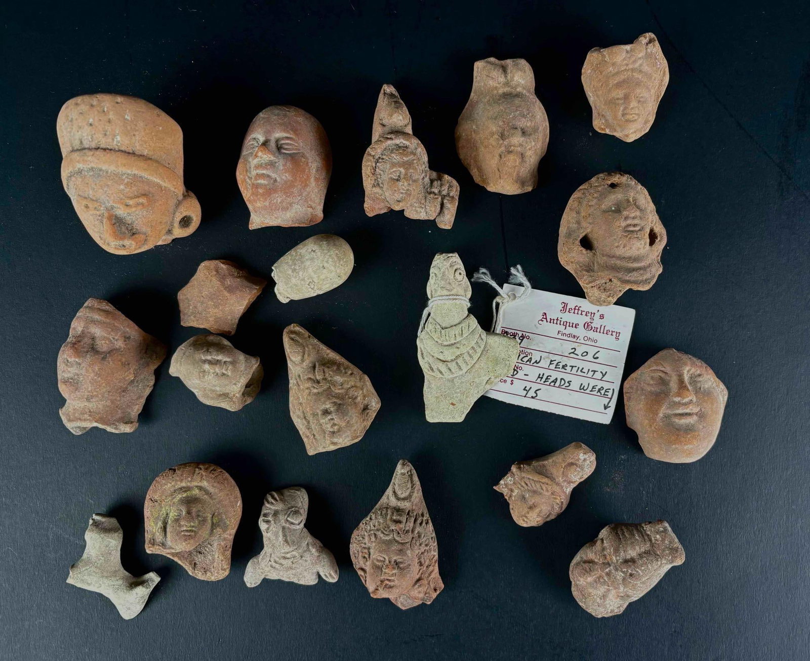 Indigenous Fertility Heads (Mexico): Mexican fertility heads from various indigenous cultures. Heads were placed in the ground at the time of planting to ensure a plentiful harvest. Terracotta. Purchased from Jeffrey's Antique Gallery in