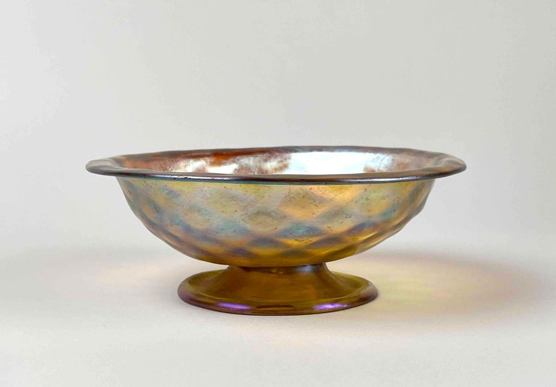 Tiffany Studios Early 20th Century Favrile Footed Bowl (Louis Comfort): Favrile footed bowl by Tiffany Studios made in early 20th century. Iridescent colors of golds, pinks, blues, greens, and purples. Signed L.C.T. on bottom of foot. From the home of Jon Jacobs, a promin