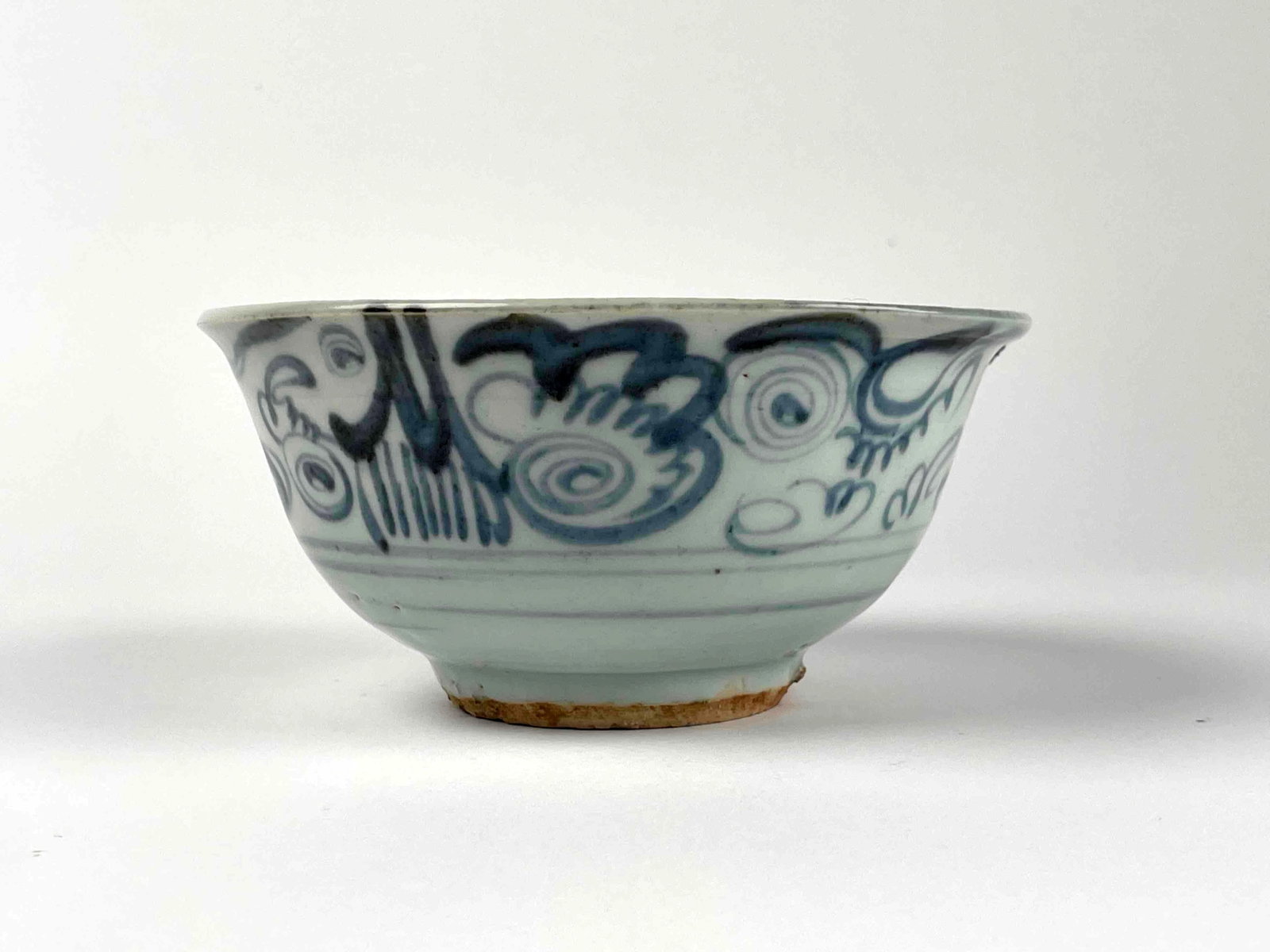 15th Century Ming Dynasty Porcelain Bowl: Chinese porcelain bowl with blue glaze decoration from the 15th century Ming Dynasty. Inside of bowl has a design made with a darker colored glaze. A tag is present on the bottom of bowl that reads "M