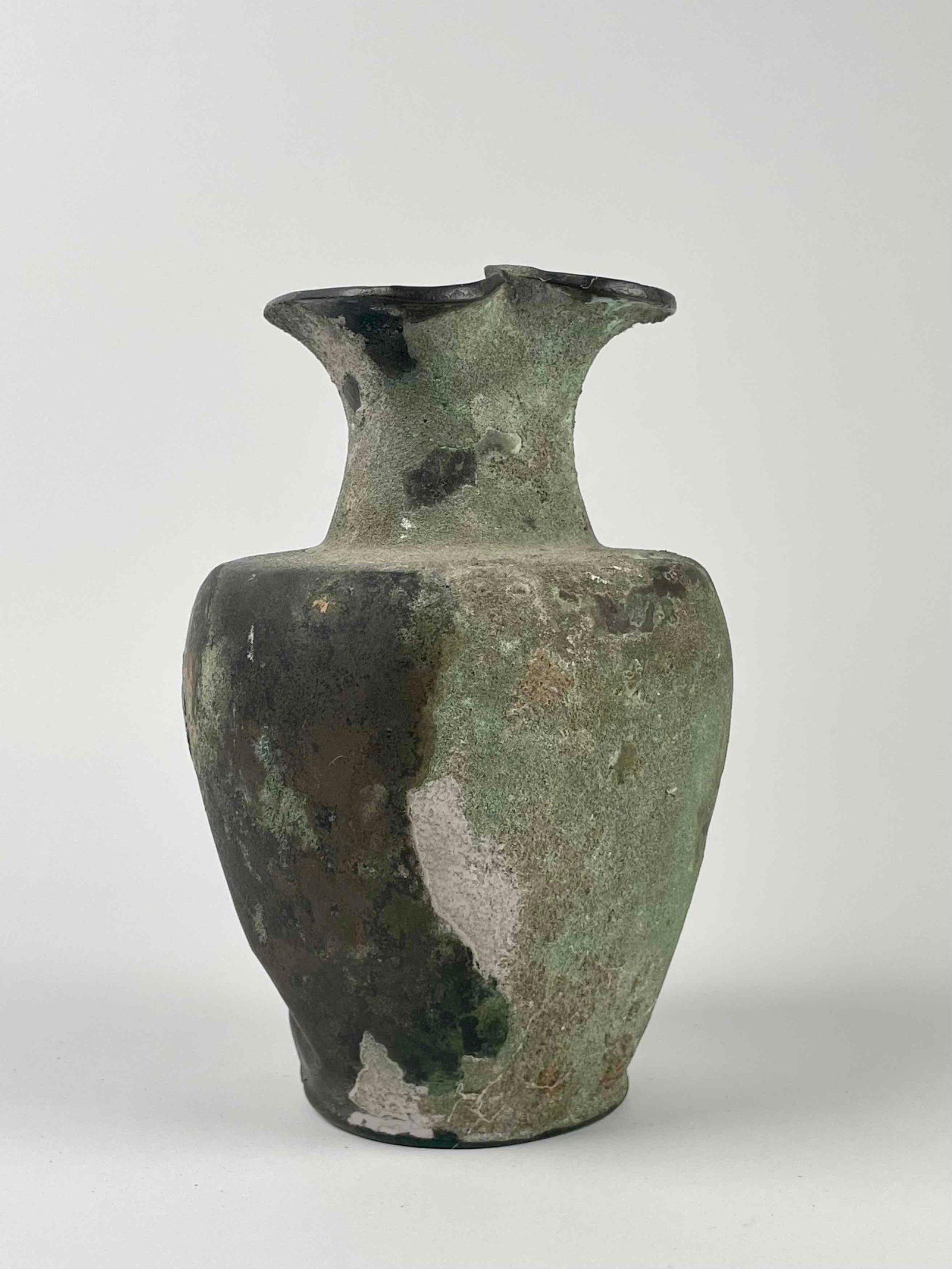 Ancient Egyptian Metal Pitcher: Ancient Egyptian pitcher. Pitcher has an elongated neck pinched mouth design. On bottom of base the numbers 26 13 are painted in red. From the home of Jon Jacobs, a prominent collector in Michigan. Pi